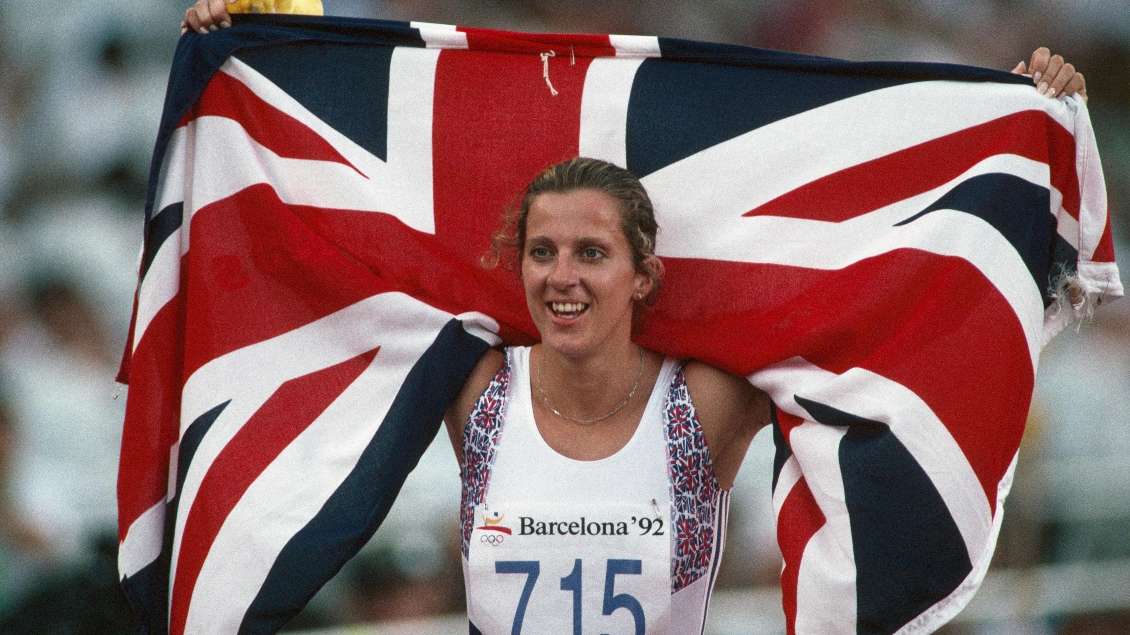 Sally Gunnell from Great Britain carries her national flag after winning the women's 400-meter hurdles at the 1992 Olympics.