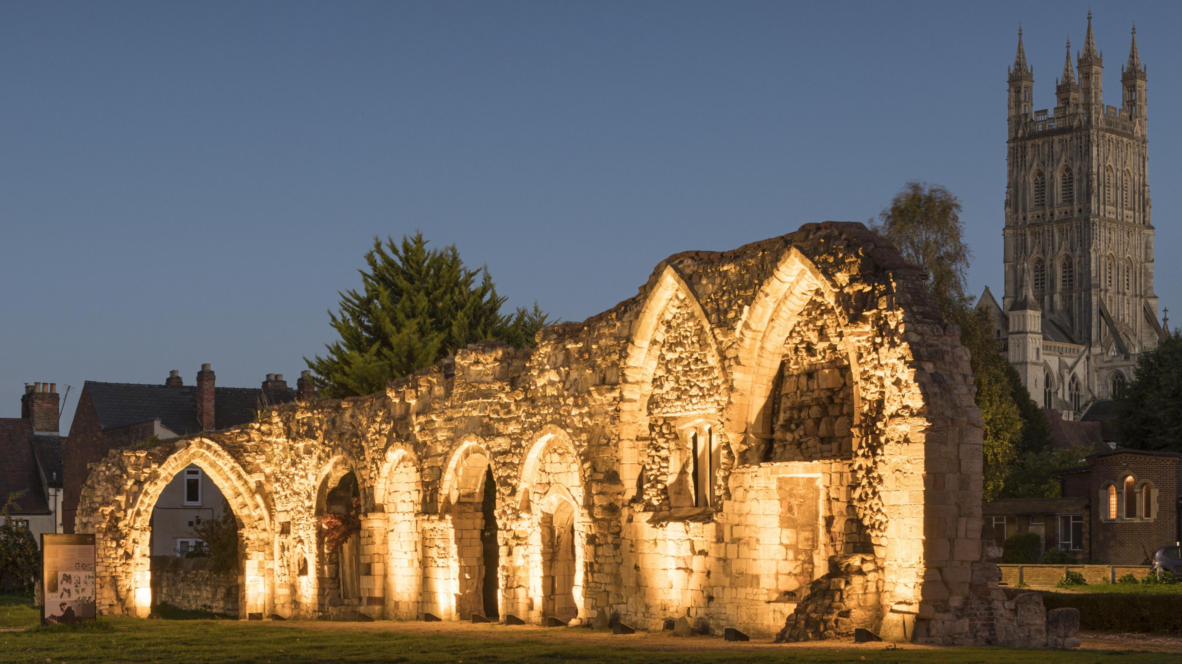 One of Gloucester's oldest medieval buildings lit up with Gloucester Cathedral in the background