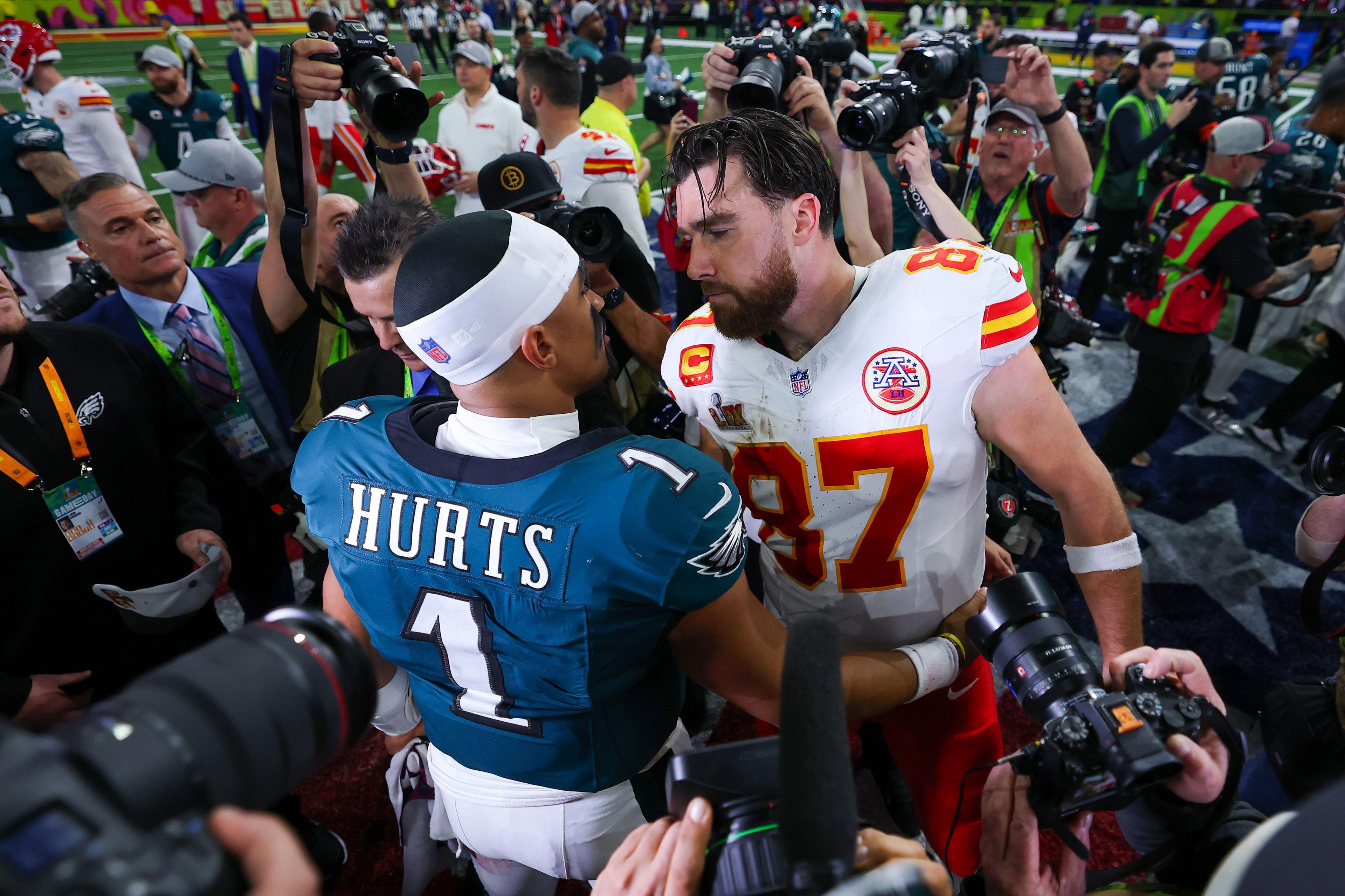 Jalen Hurts of the Philadelphia Eagles and Travis Kelce of the Kansas City Chiefs meet after Philadelphia beat Kansas City 40-22 to win Super Bowl