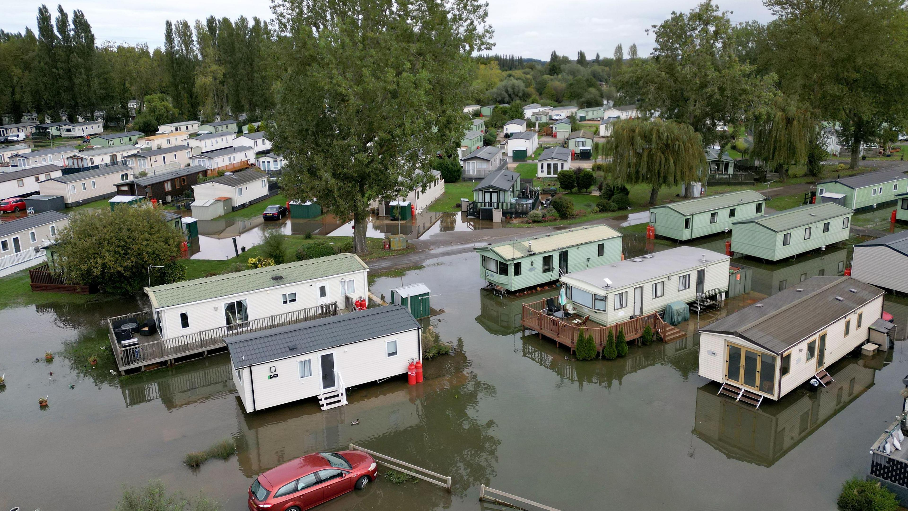 A car sits in floodwater at the Billing Aquadrome holiday park, Northamptonshire, where firefighters and police worked until late on Tuesday night as flooding forced 43 residents to evacuate