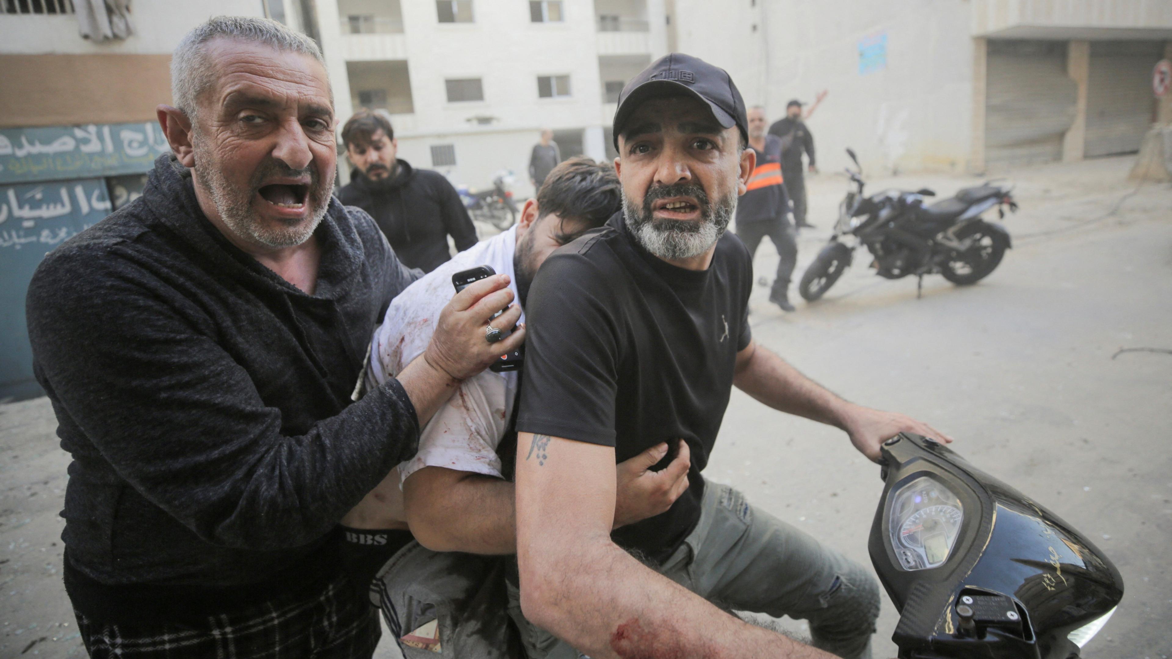 People evacuate a wounded man, after an Israeli strike on the Mreijeh neighbourhood in Beirut's southern suburbs, amid cross-border hostilities between Hezbollah and Israel, in Beirut, Lebanon