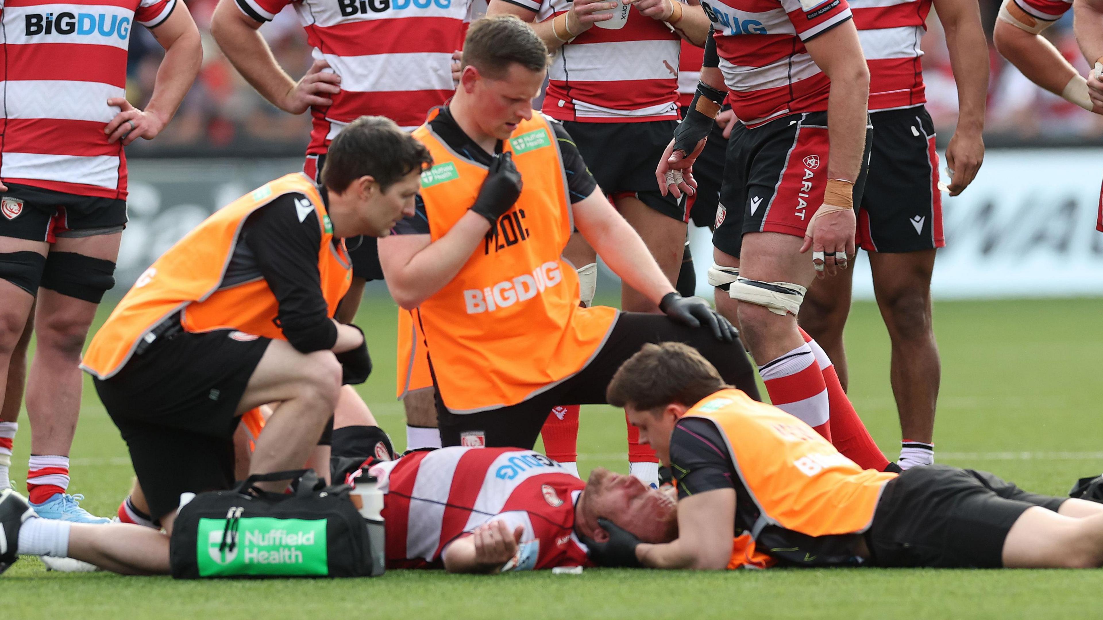 Jack Innard has treatment for a concussion after being struck by Roots after a tackle