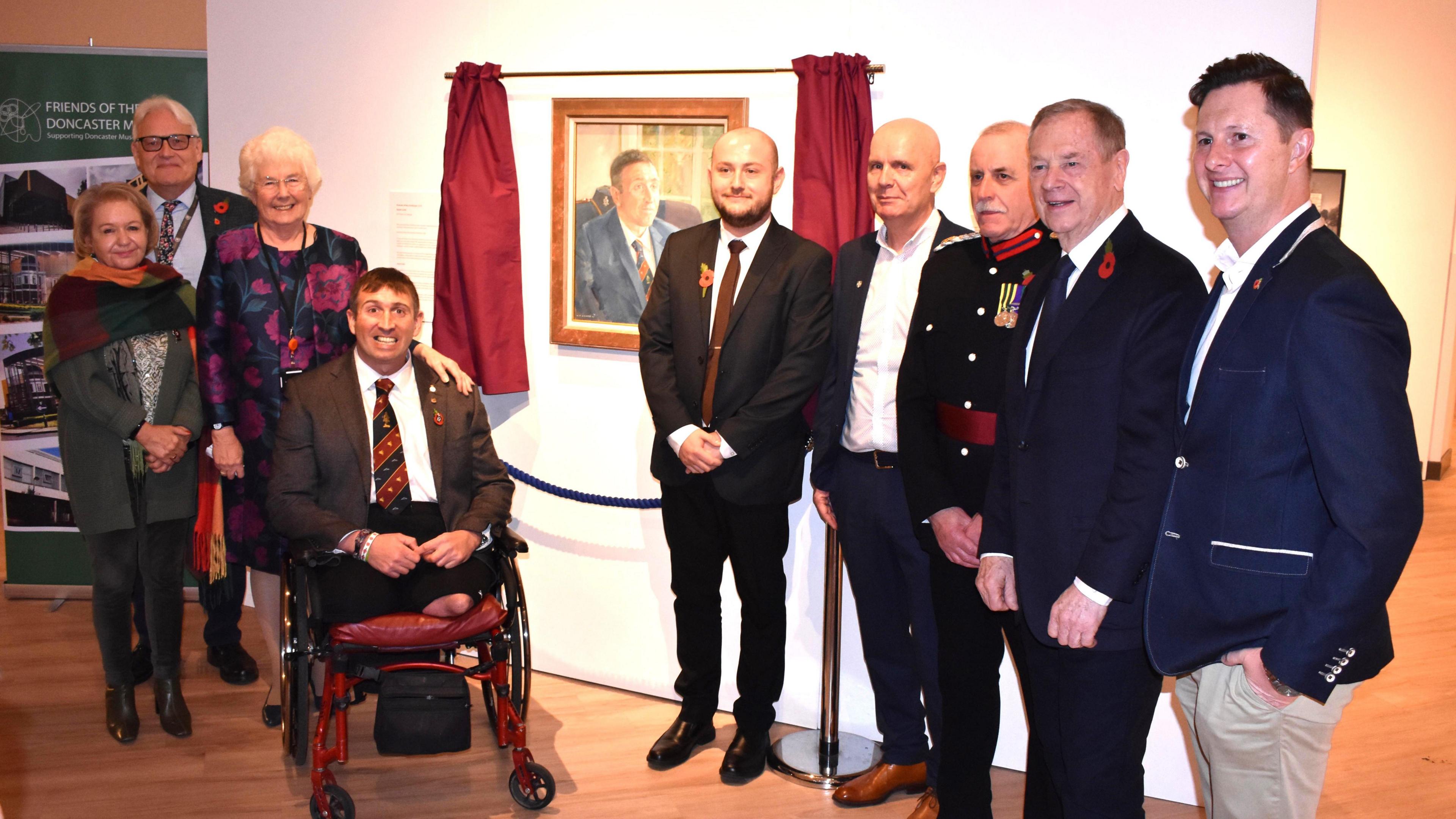 Former British paratrooper Ben Parkinson with a group of people at the unveiling of his portrait