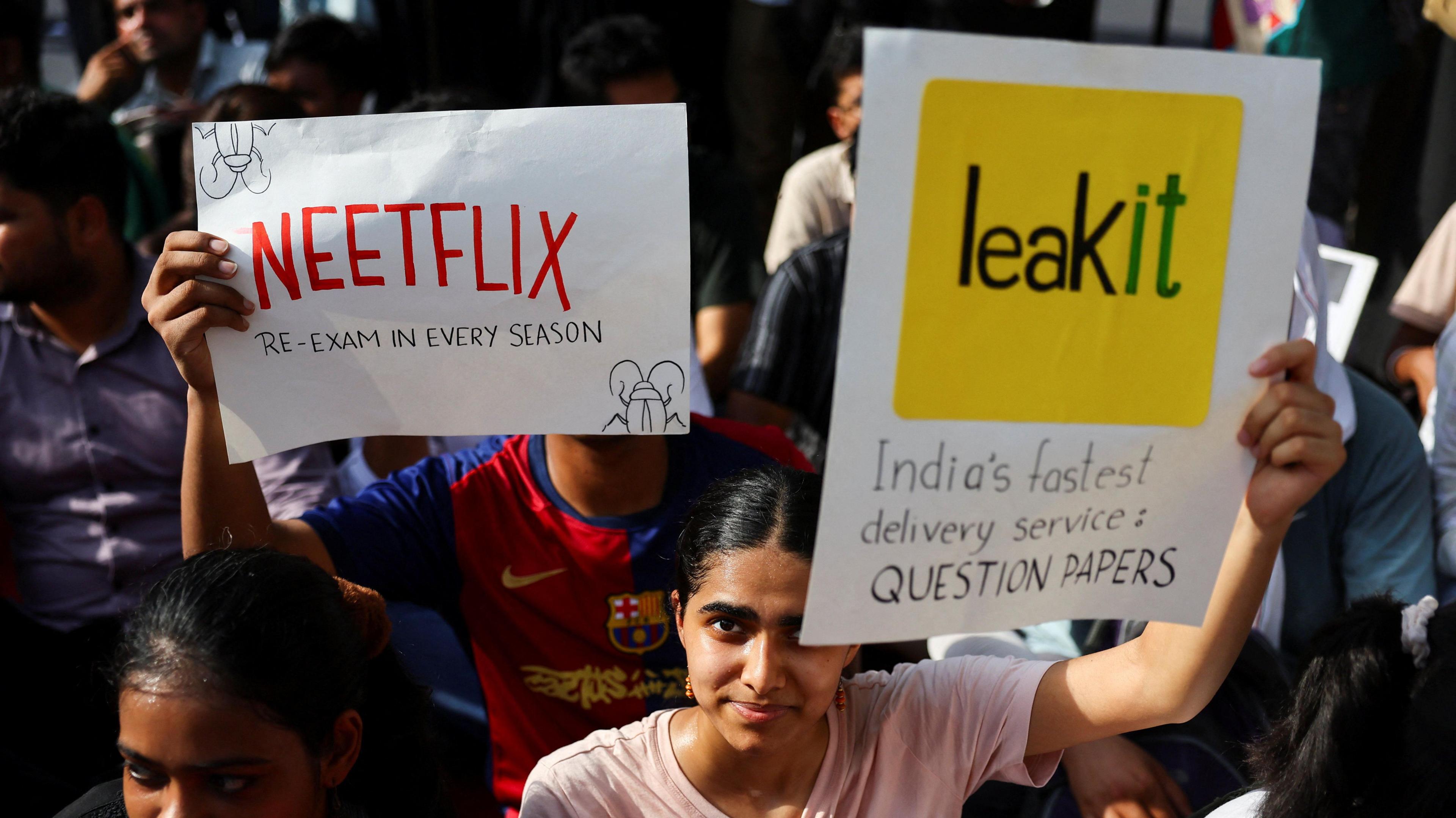 People hold placards and shout slogans during a sit-in protest called by Cockroach Janta Party (CJP) demanding the resignation of Indian Education Minister Dharmendra Pradhan, at Jantar Mantar in New Delhi, India, June 21, 2026. 