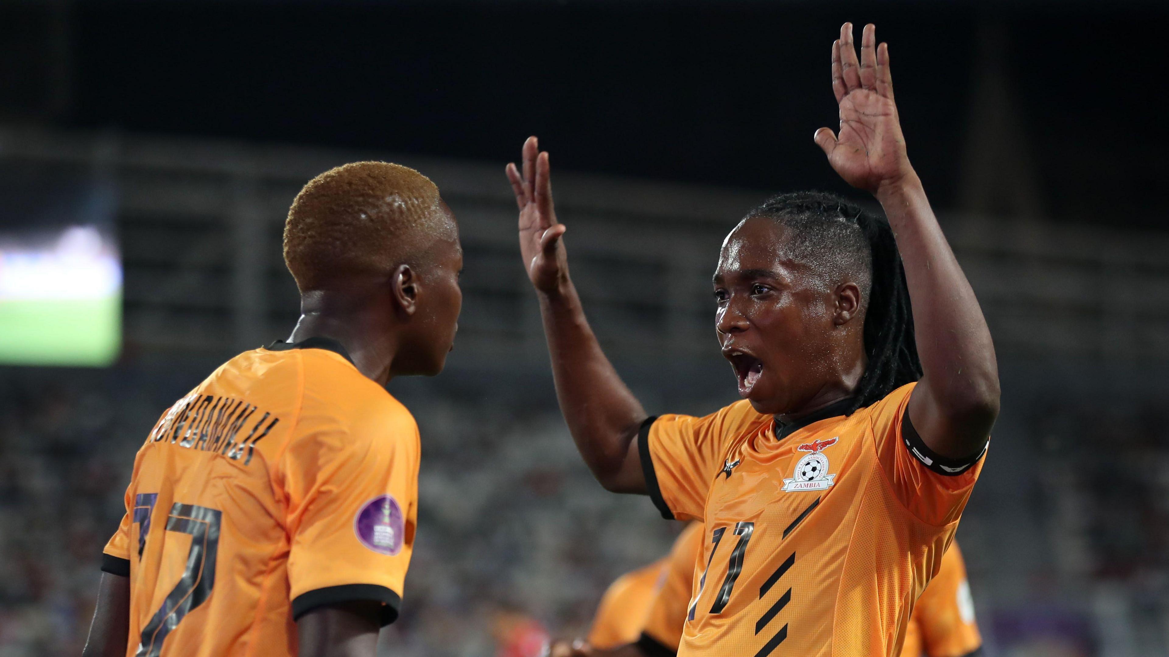 Zambia captain Barbra Banda raises both hands in the air as she celebrates a goal with team-mate Racheal Kundananji