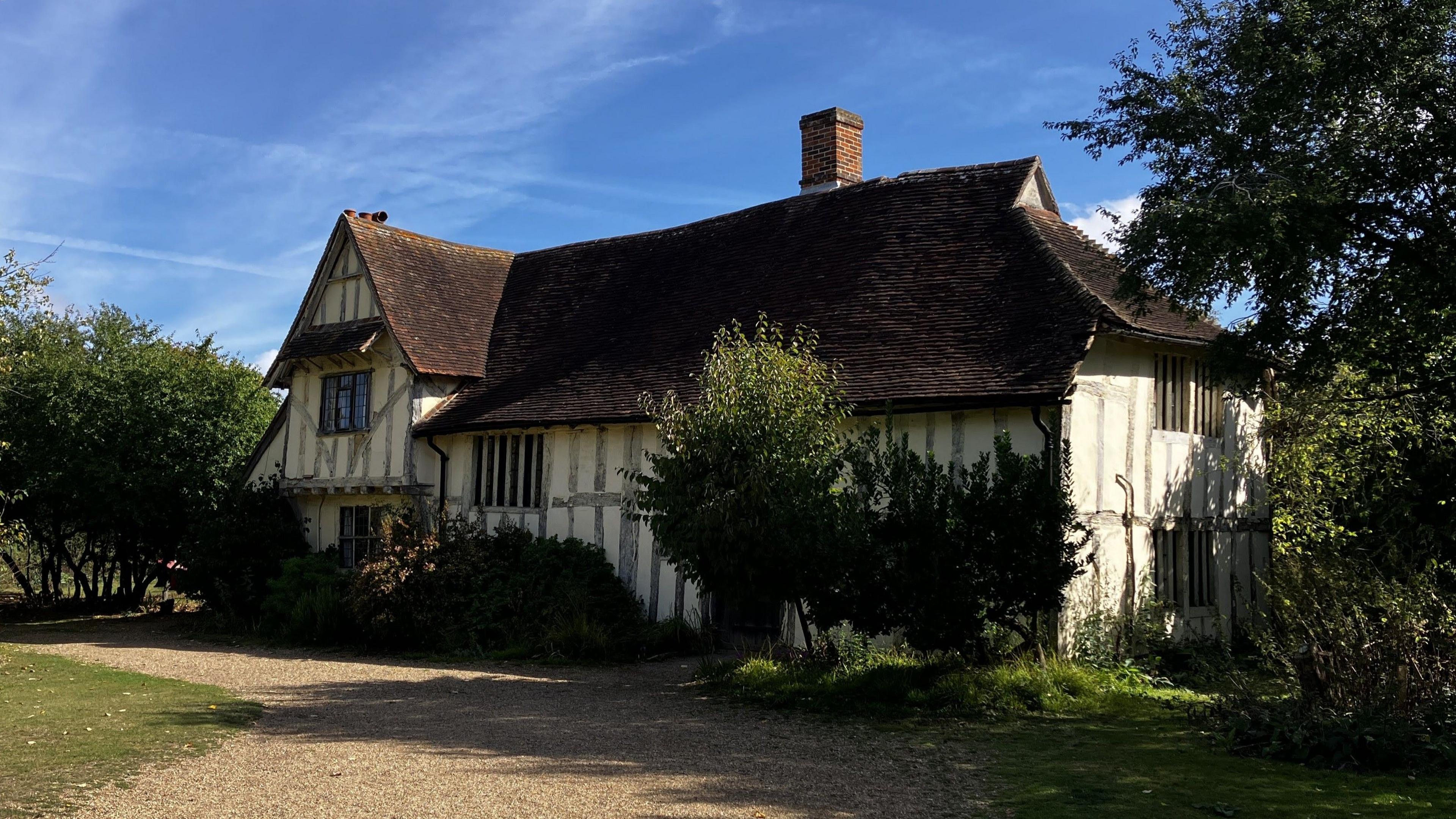 Valley Farm in Flatford today. It is a medieval building with wooden beams on its exterior and wooden-framed windows.