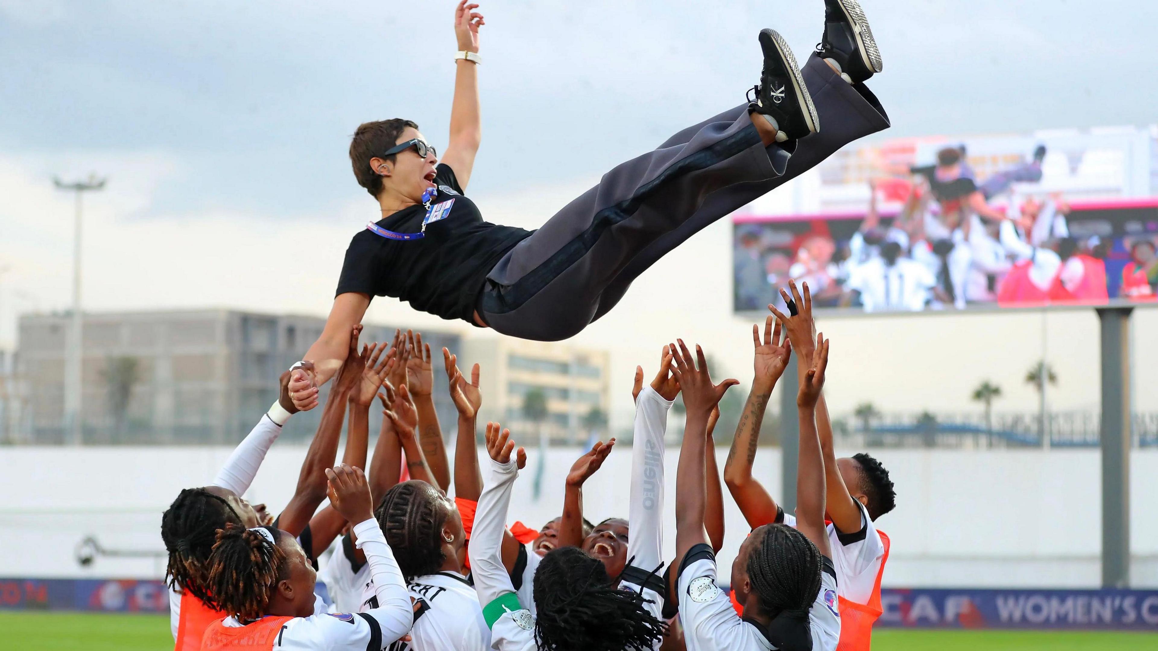 TP Mazembe boss Lamia Boumehdi is thrown into the air by players as they celebrate a victory at the African Women's Champions League