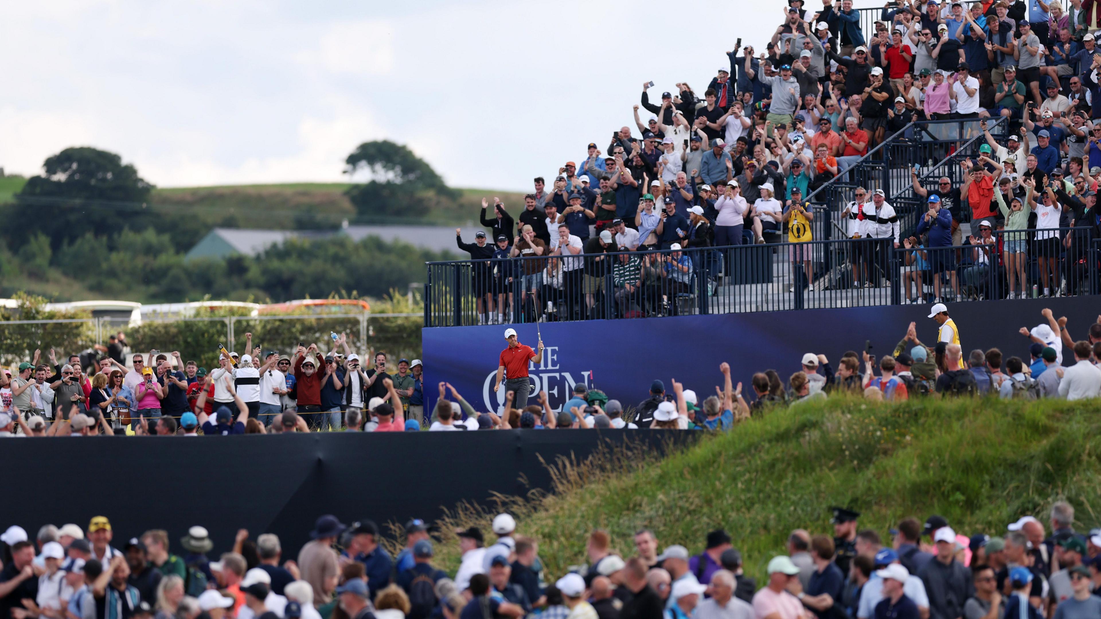 Rory McIlroy salutes the crowd after his eagle on the 12th