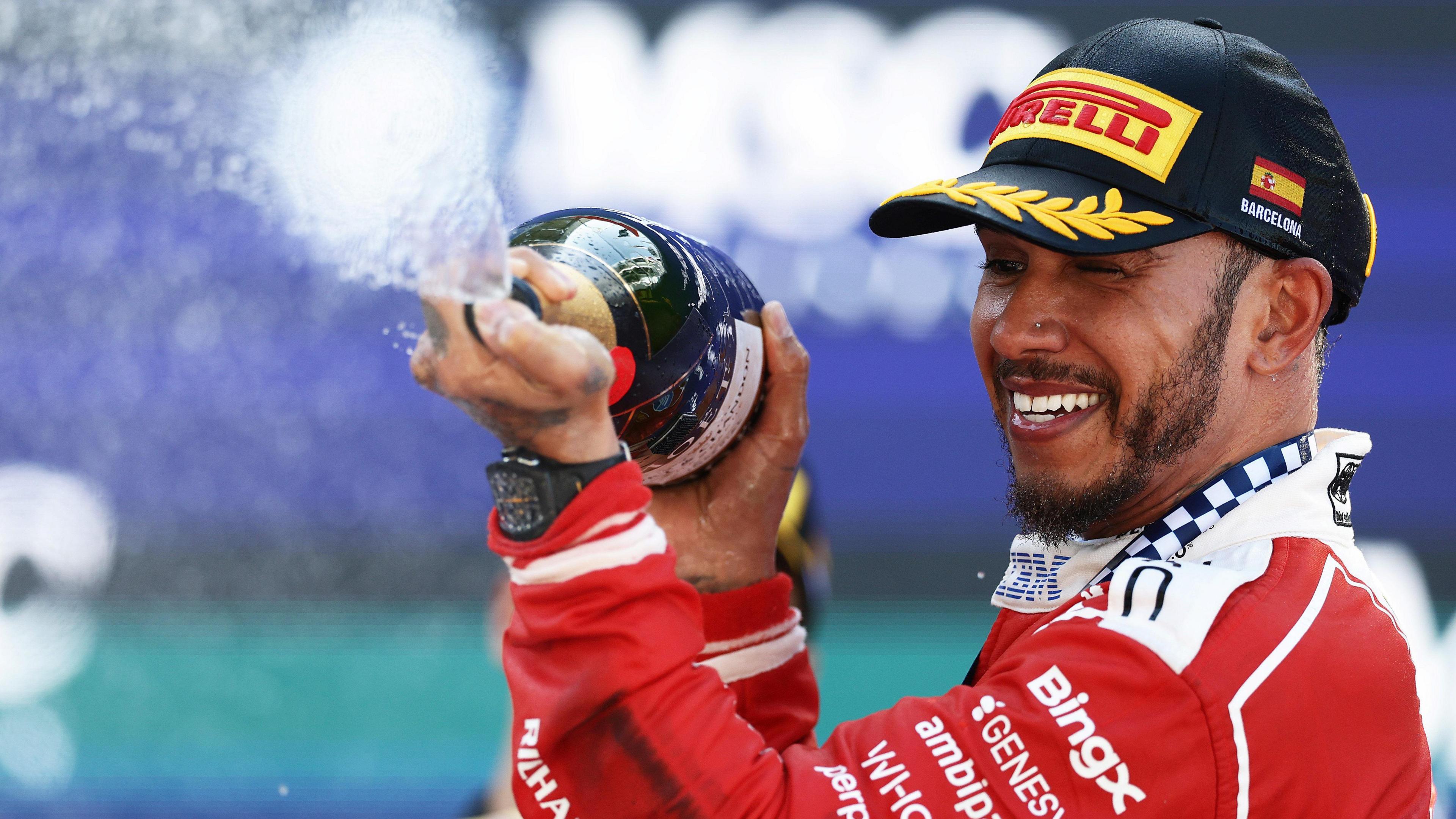 Ferrari's Lewis Hamilton sprays champagne on the podium after winning the Barcelona-Catalunya Grand Prix