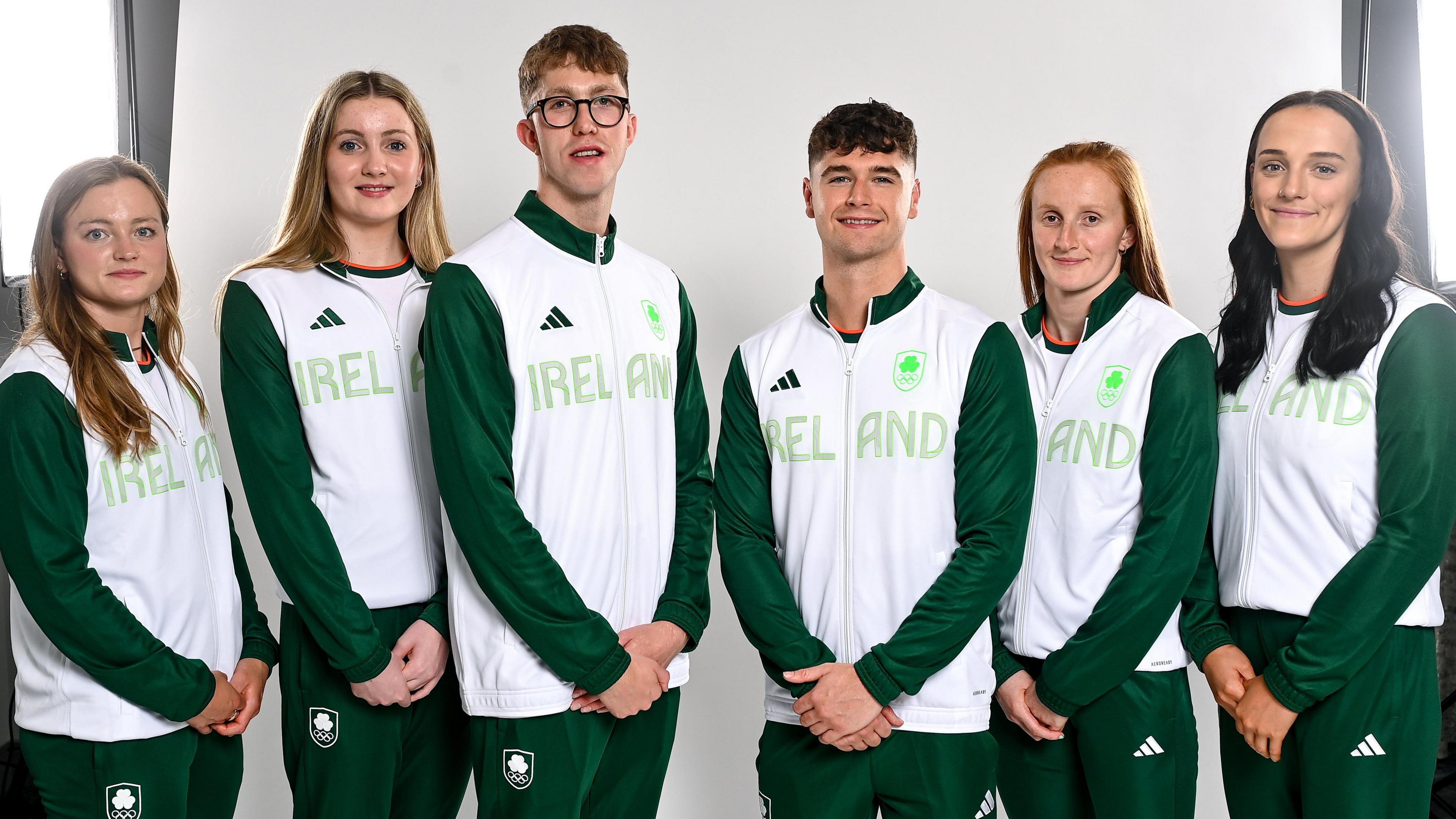 6 adults wearing green and white Team Ireland tracksuits