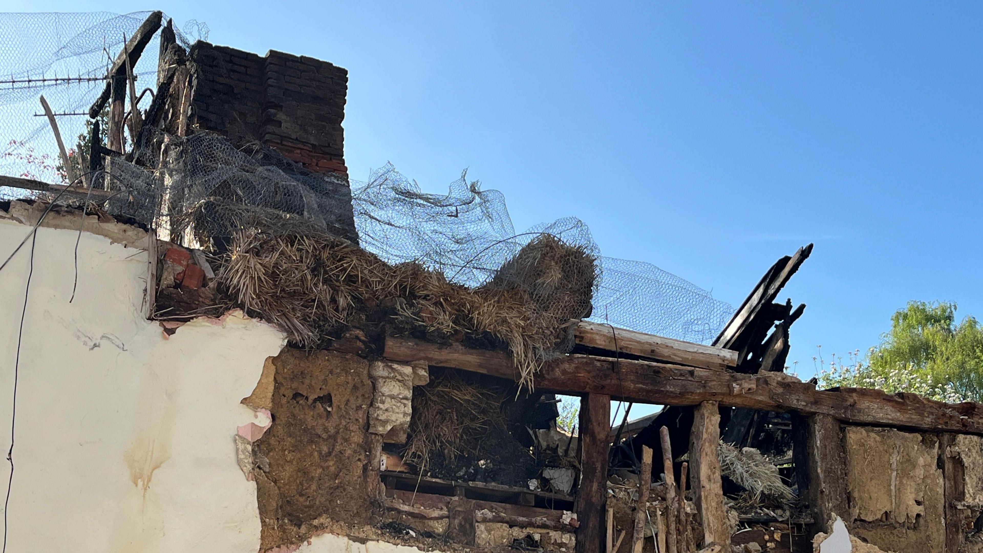 A thatched cottages in Bardwell which can be seen badly damaged by a fire. Its roof is completely destroyed.