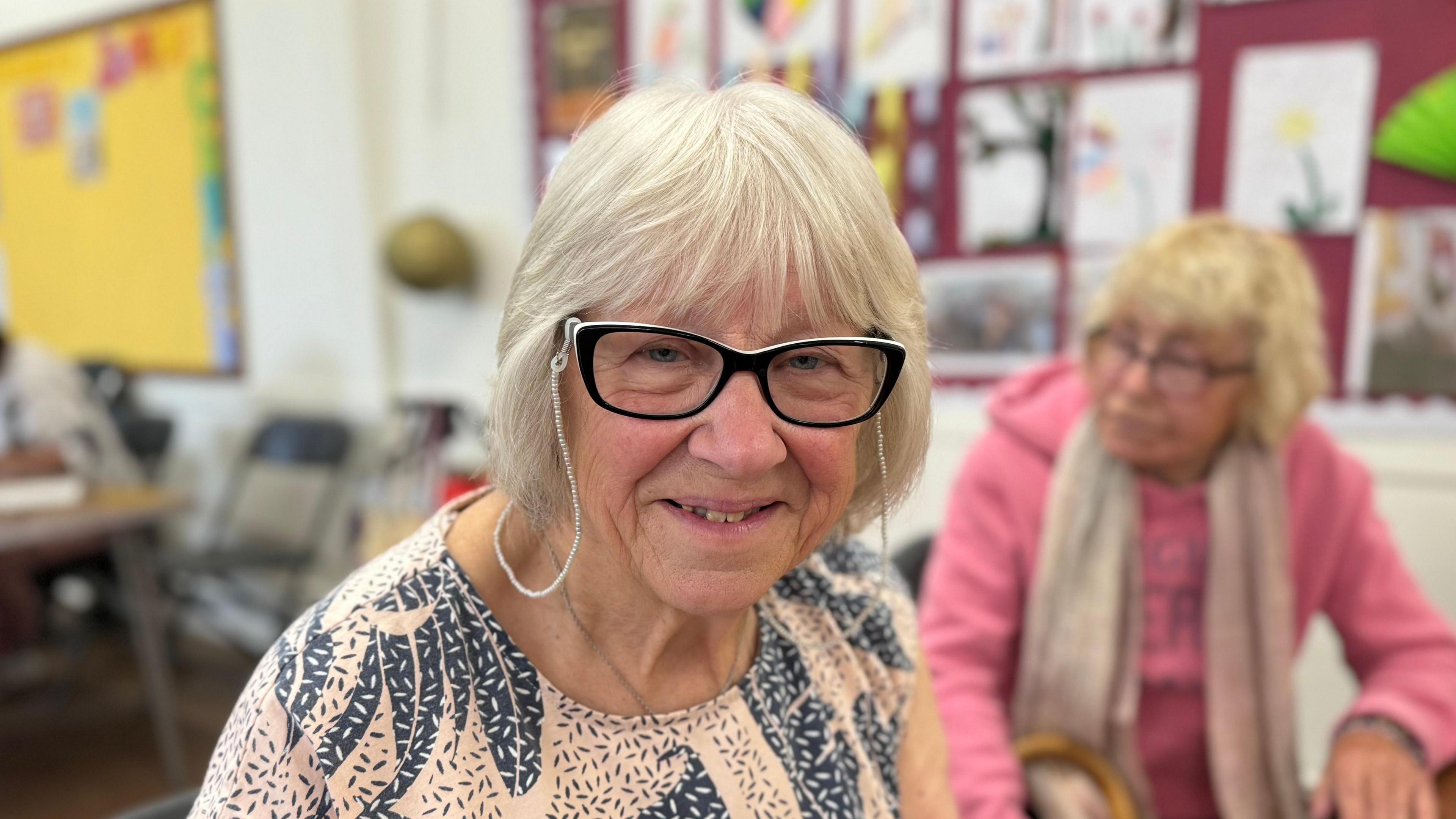 Pensioner Carol Bennett smiling while wearing glasses 