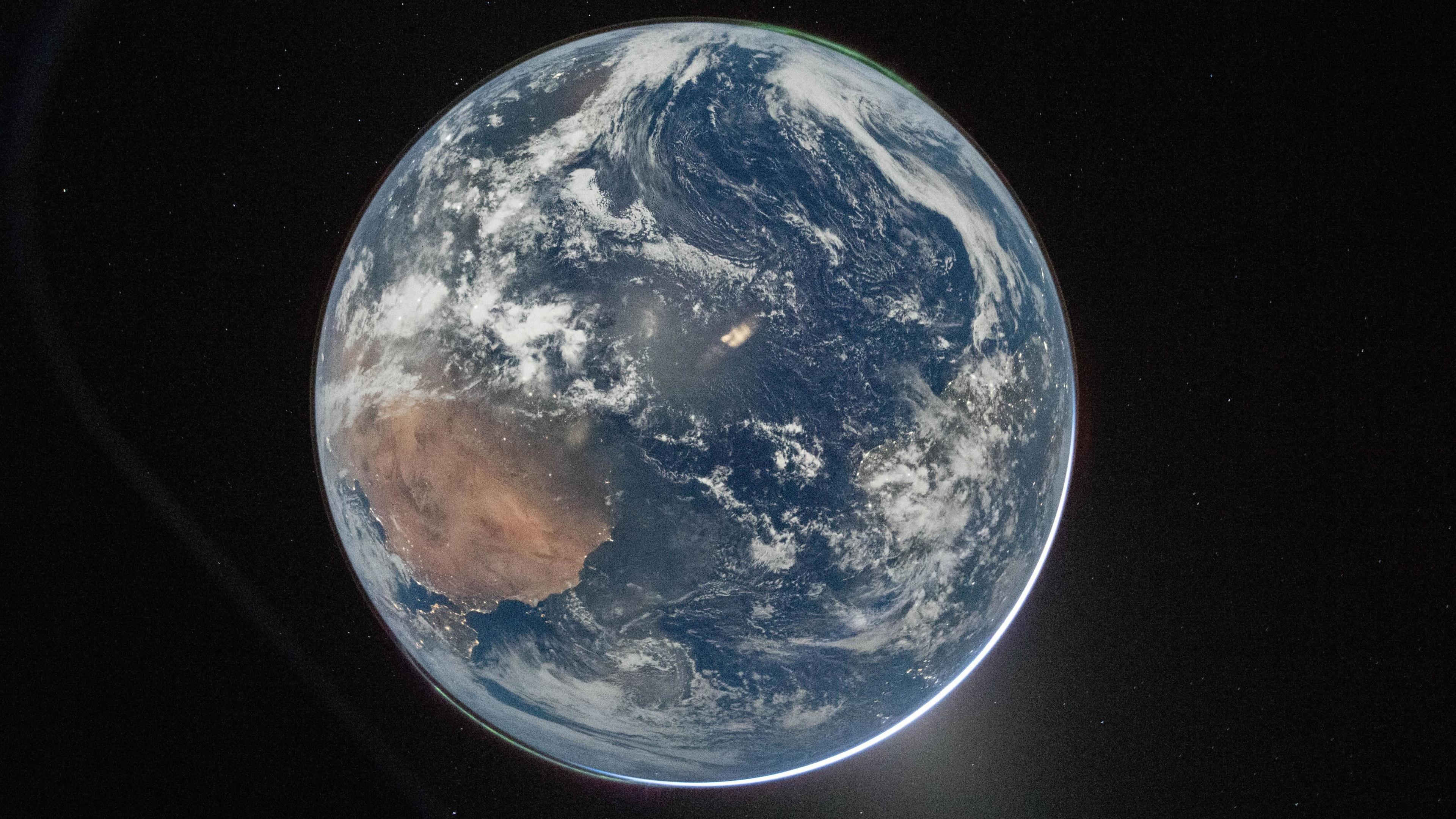 A picture of the Earth from space, which centres the planet against a dark background. 