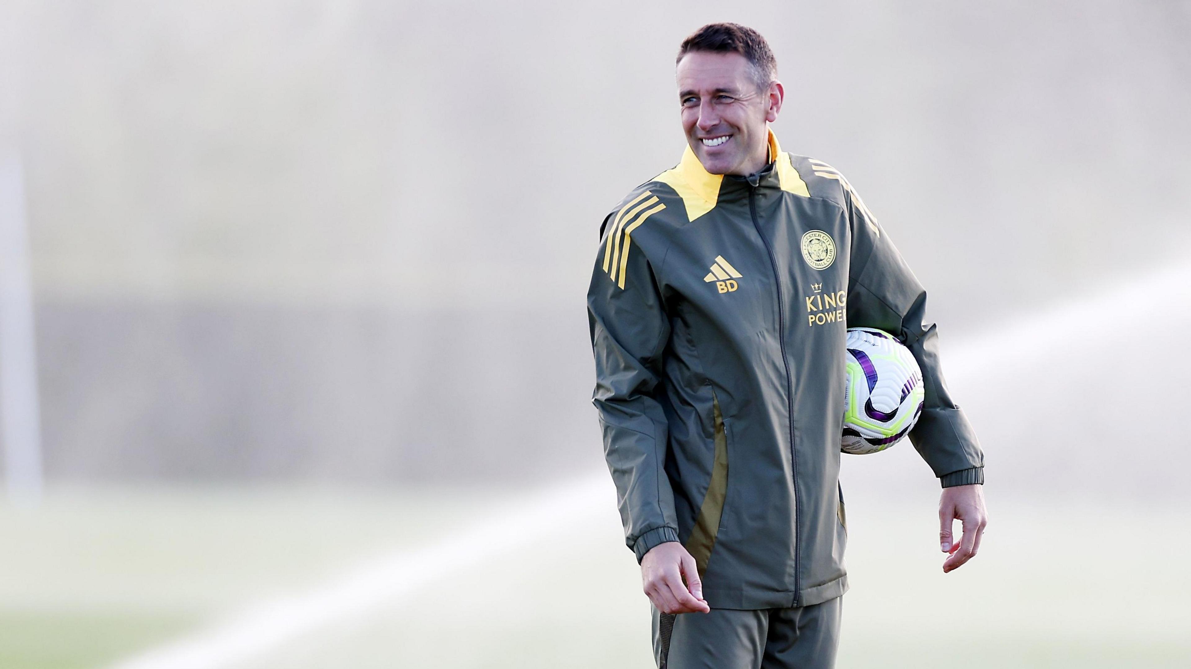 Ben Dawson smiles as he watches a Leicester training session