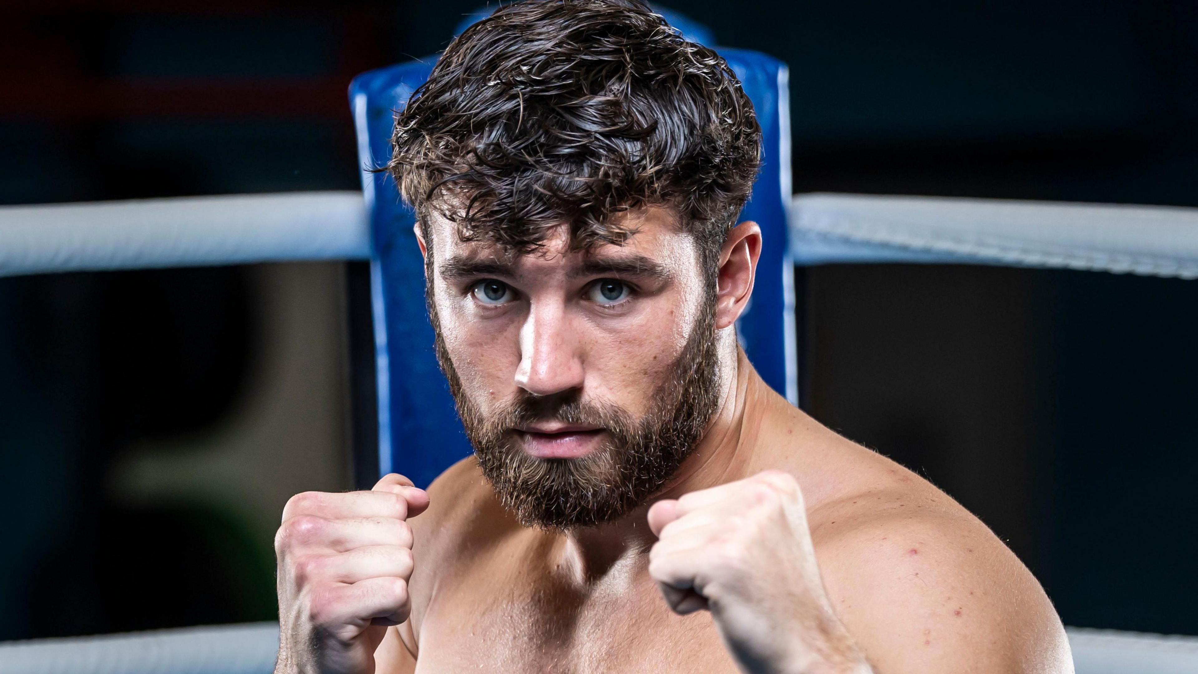 Patrick Brown with his fists up and posing for a TeamGB media day