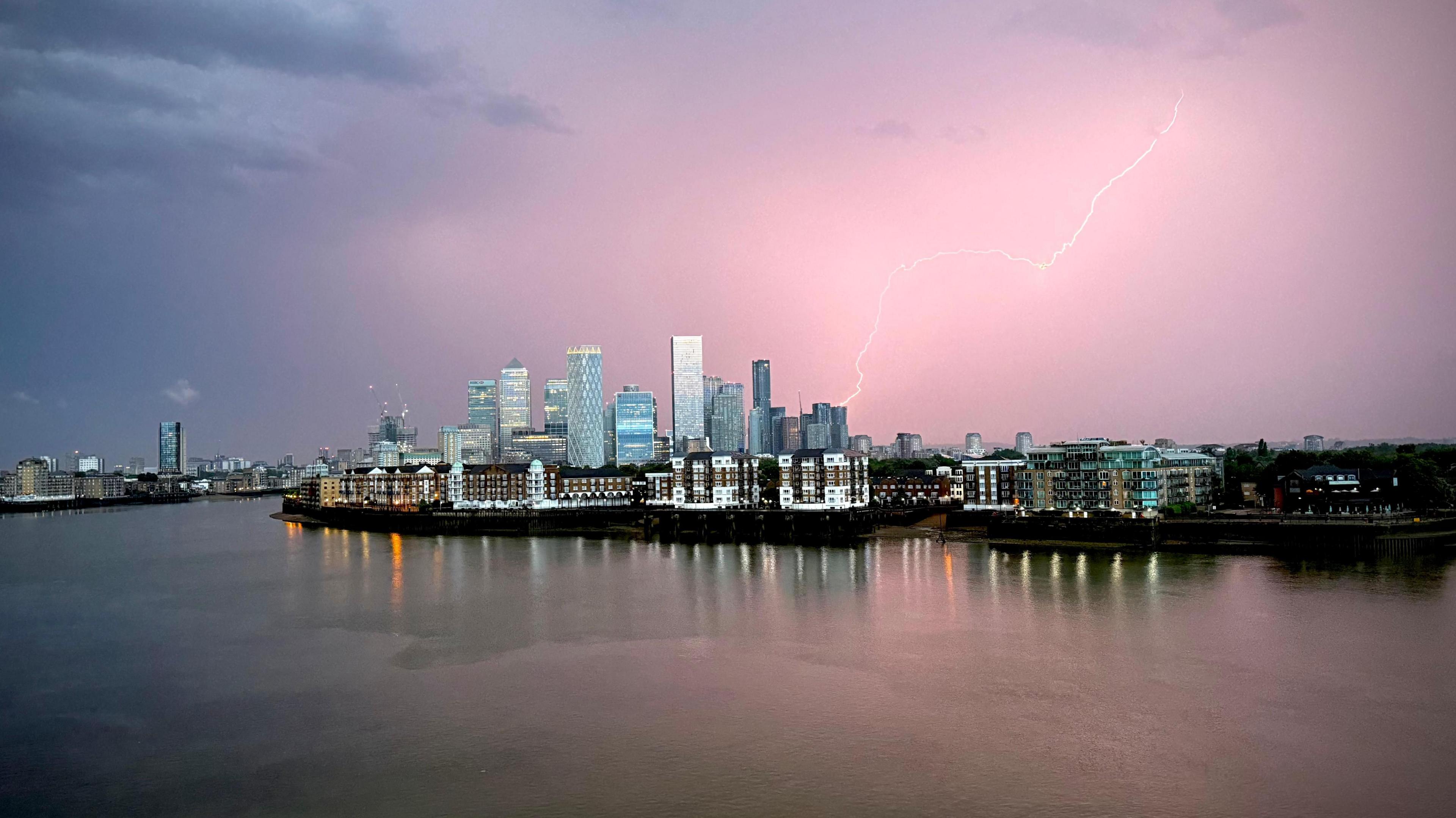 A lightning bolt is seen above building in Canary Wharf
