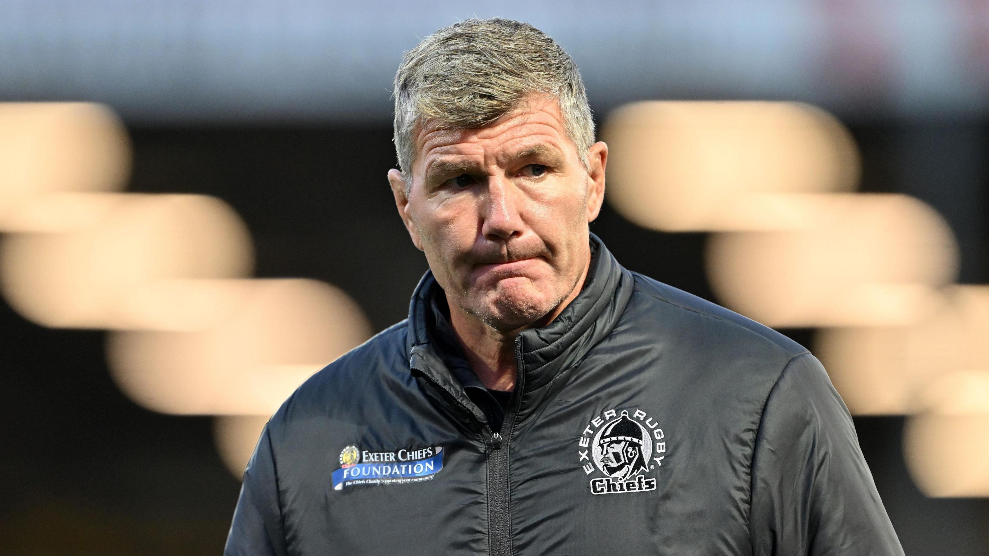 Rob Baxter standing looking to the side