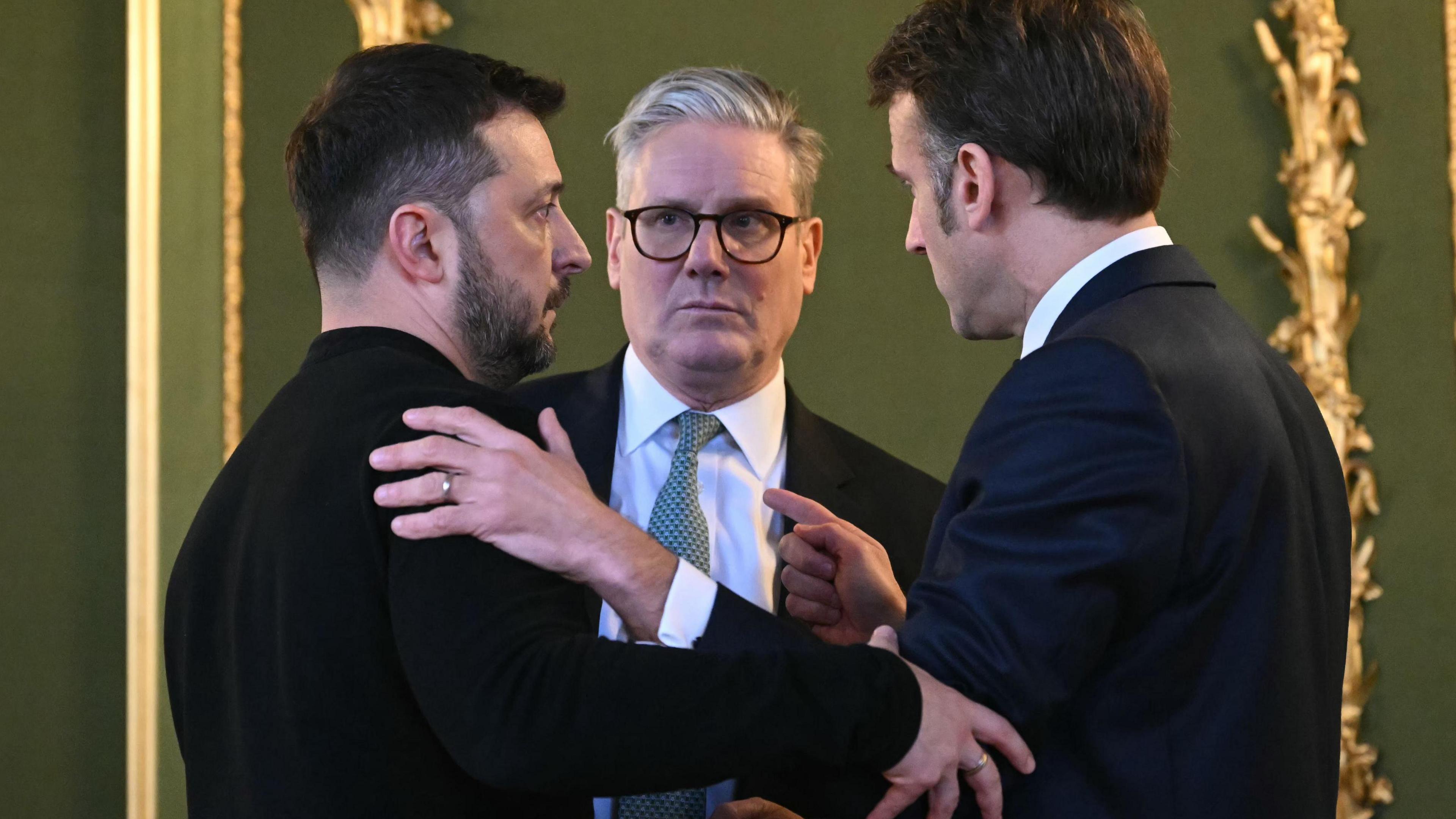 Volodymyr Zelensky, Keir Starmer and Emmanuel Macron chat after holding a meeting during a summit on Ukraine at Lancaster House in London, UK, on 2 March 2025.