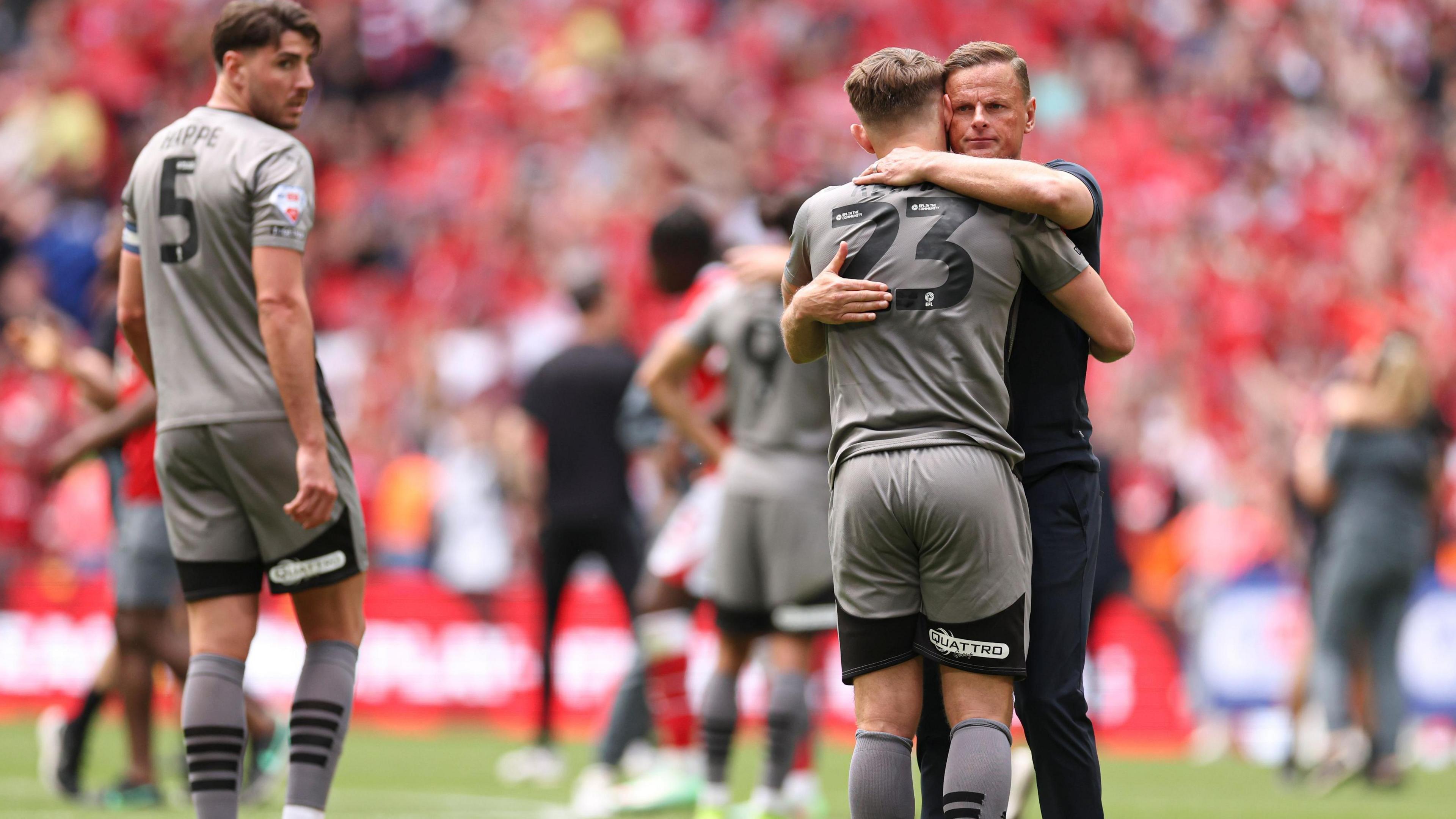 Leyton Orient boss Richie Wellens consoles Charlie Kelman after the O's defeat to Charlton Athletic