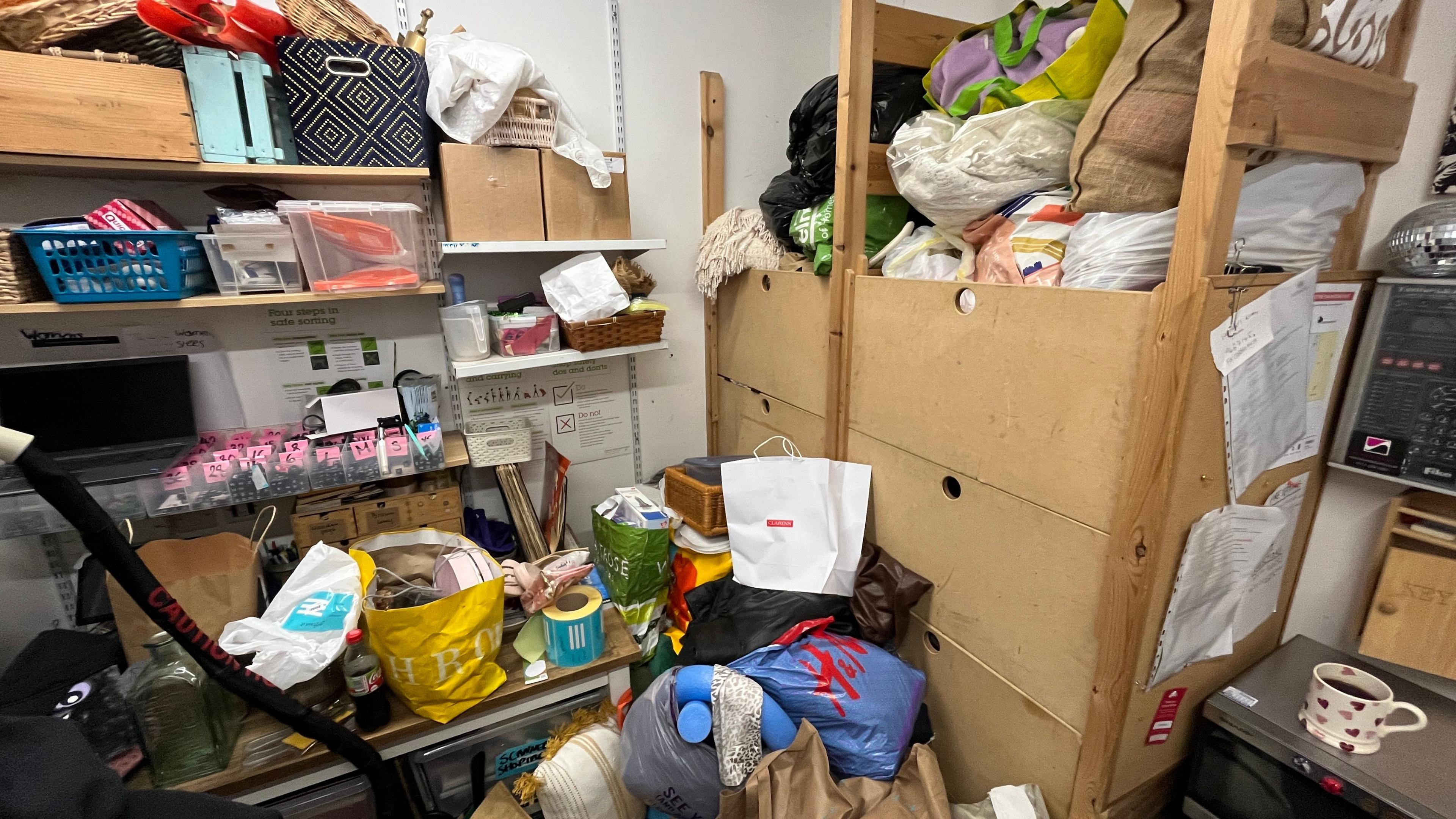 Donated goods in a charity shop store room