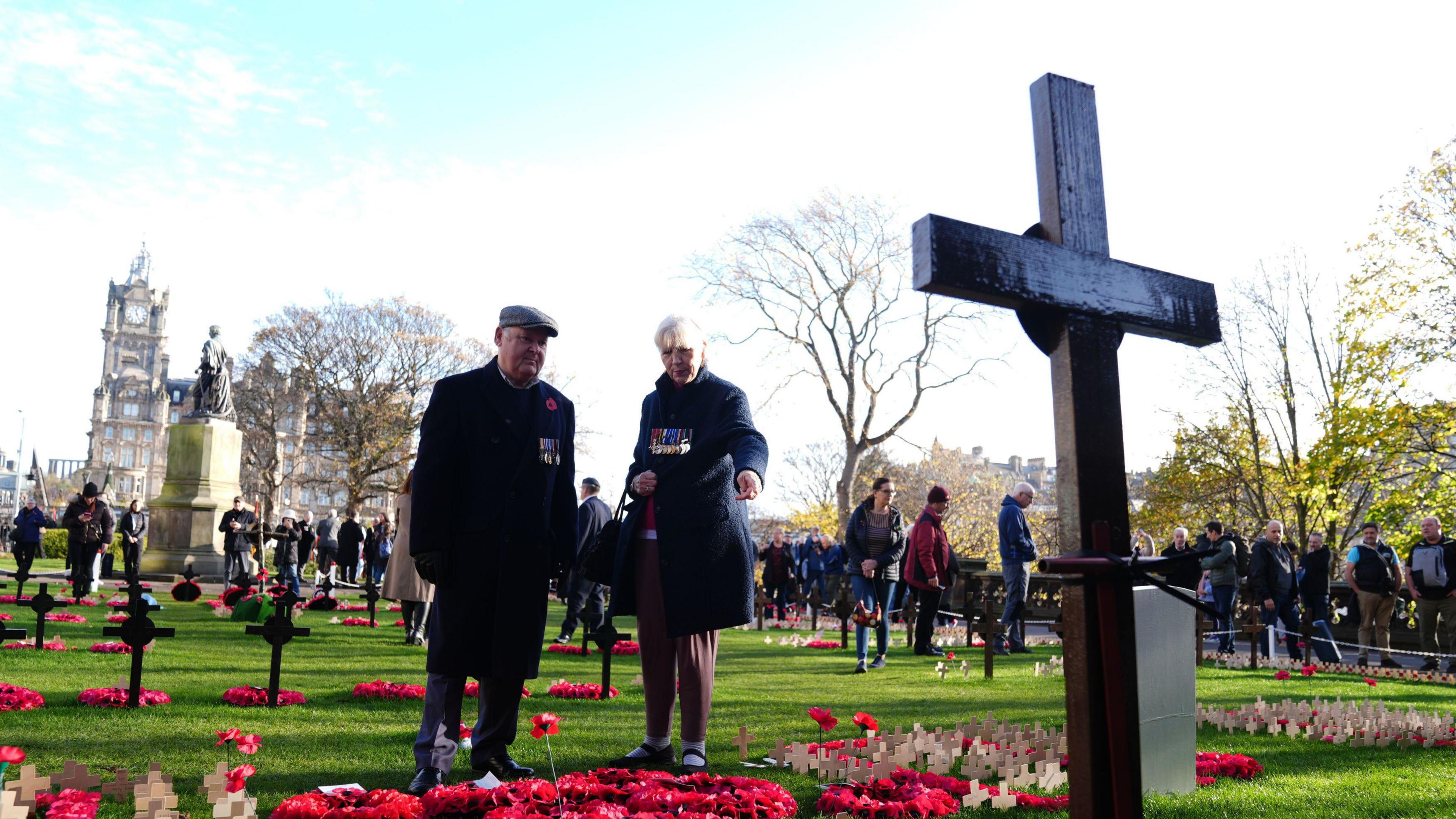 People look at wreaths following a ceremony to mark Armistice Day in the Garden of Remembrance near the Scott Monument in Princes Street Gardens, Edinburgh.