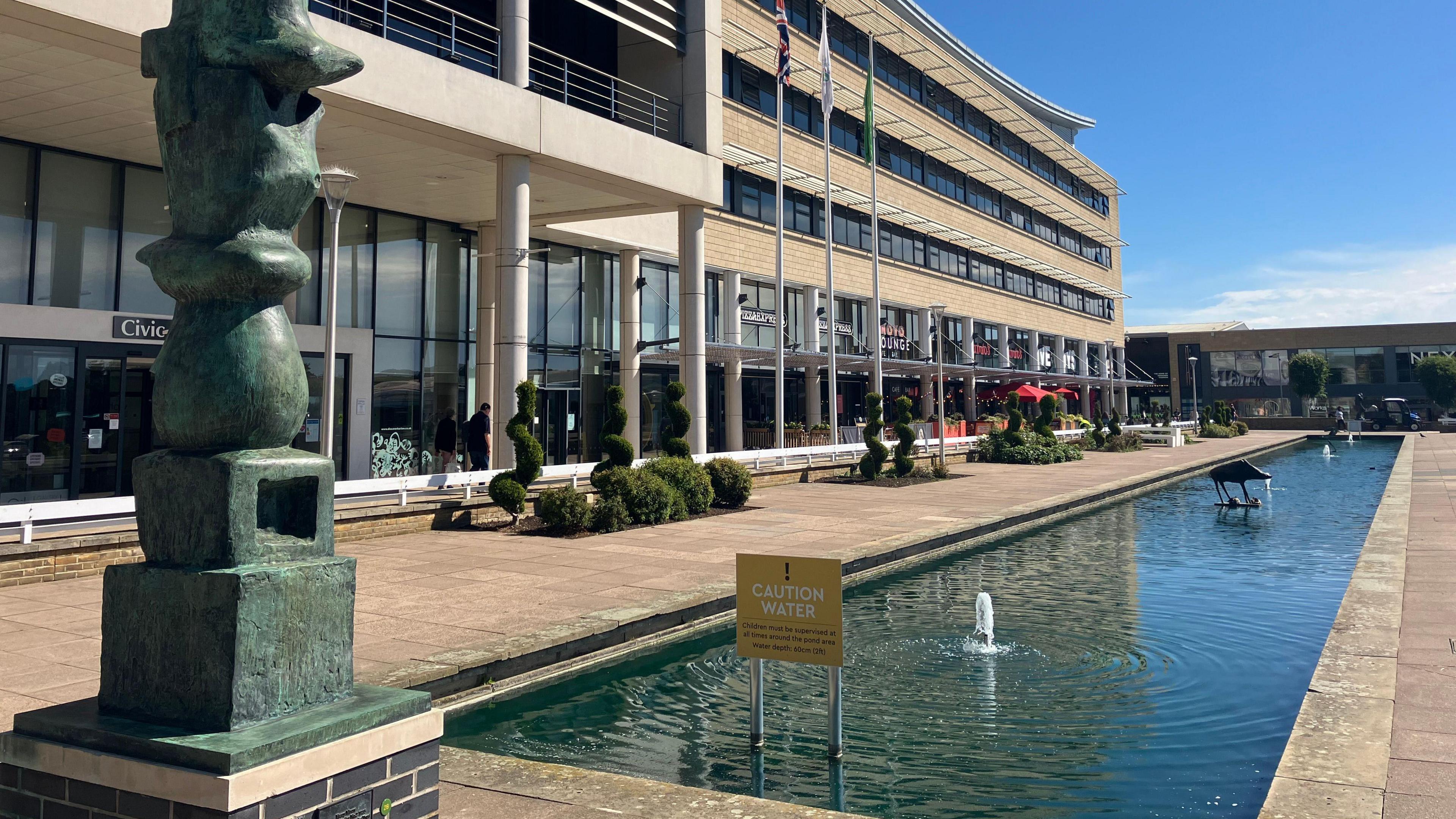 A look towards a pond and fountain in Harlow's Water Gardens