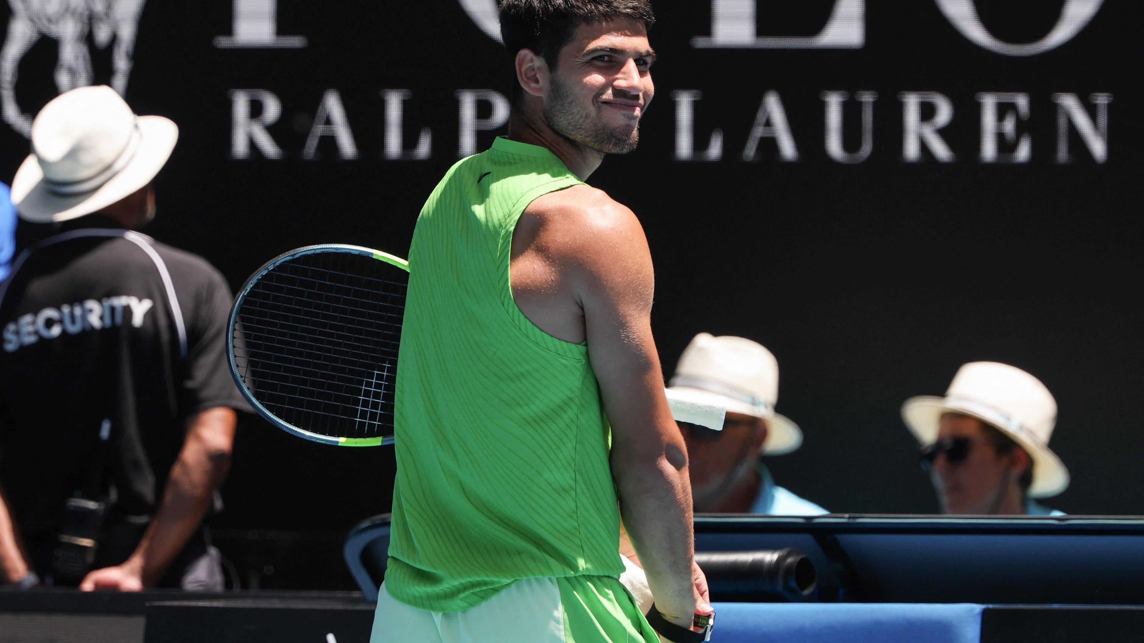 Carlos Alcaraz takes off a fitness device known as a wearable