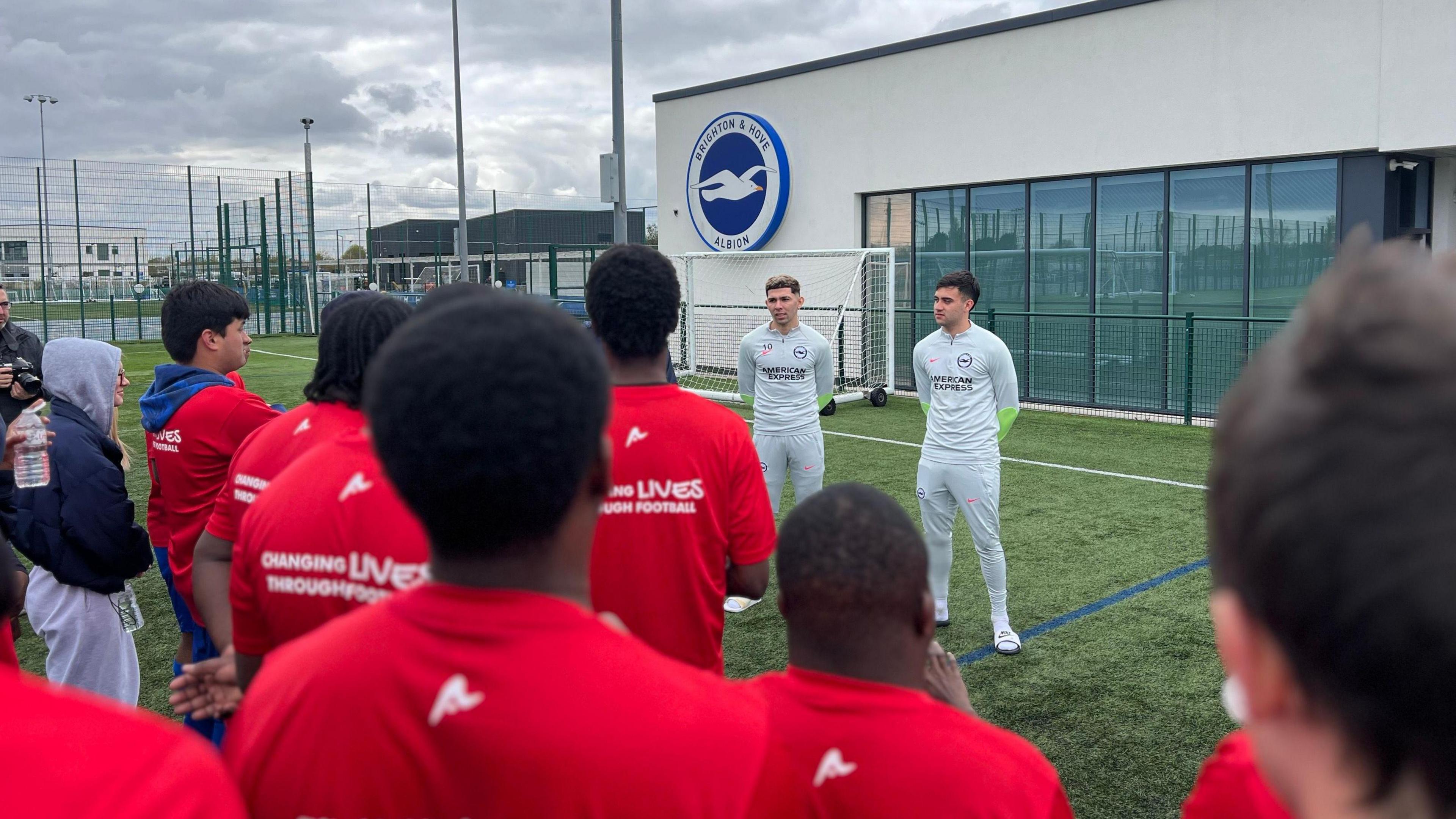 Brighton players Facundo Buonanotte and Julio Enciso speaking to Street Soccer Academy members