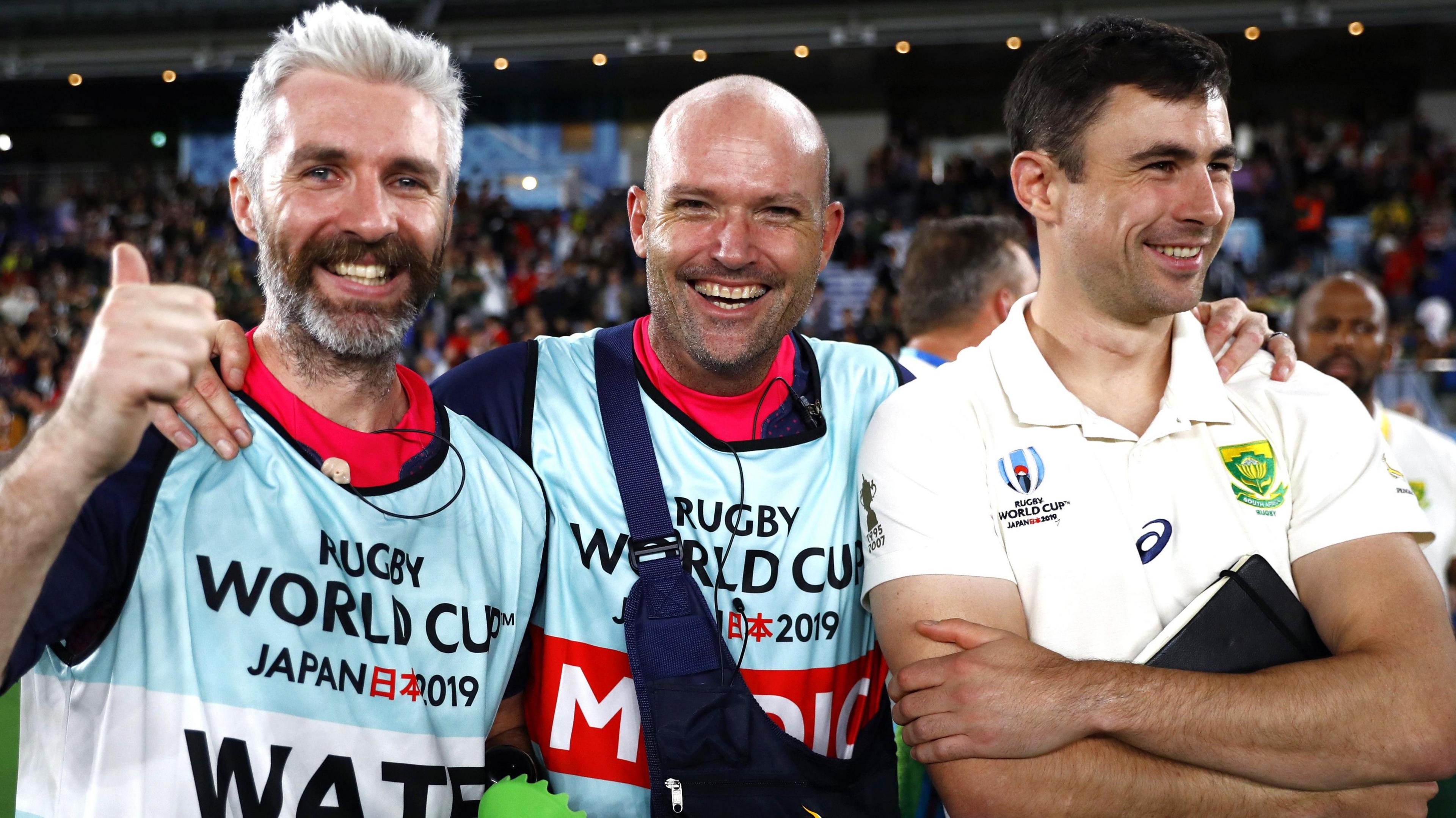 Aled Walters, Jacques Nienaber, and Felix Jones pose after South Africa's win over England at the 2019 Rugby World Cup final