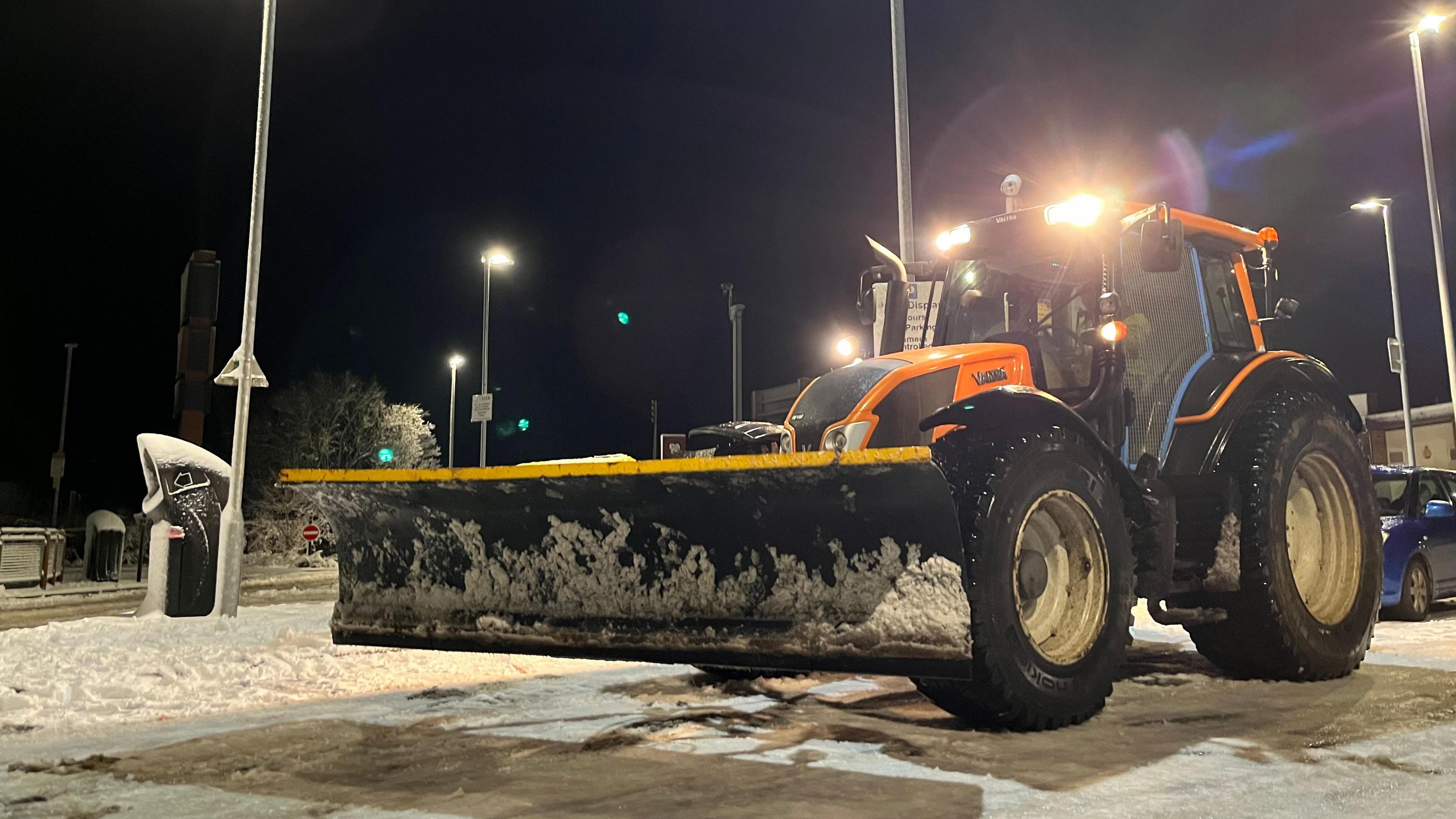 A picture of a tractor snow plough driving near to the A38.