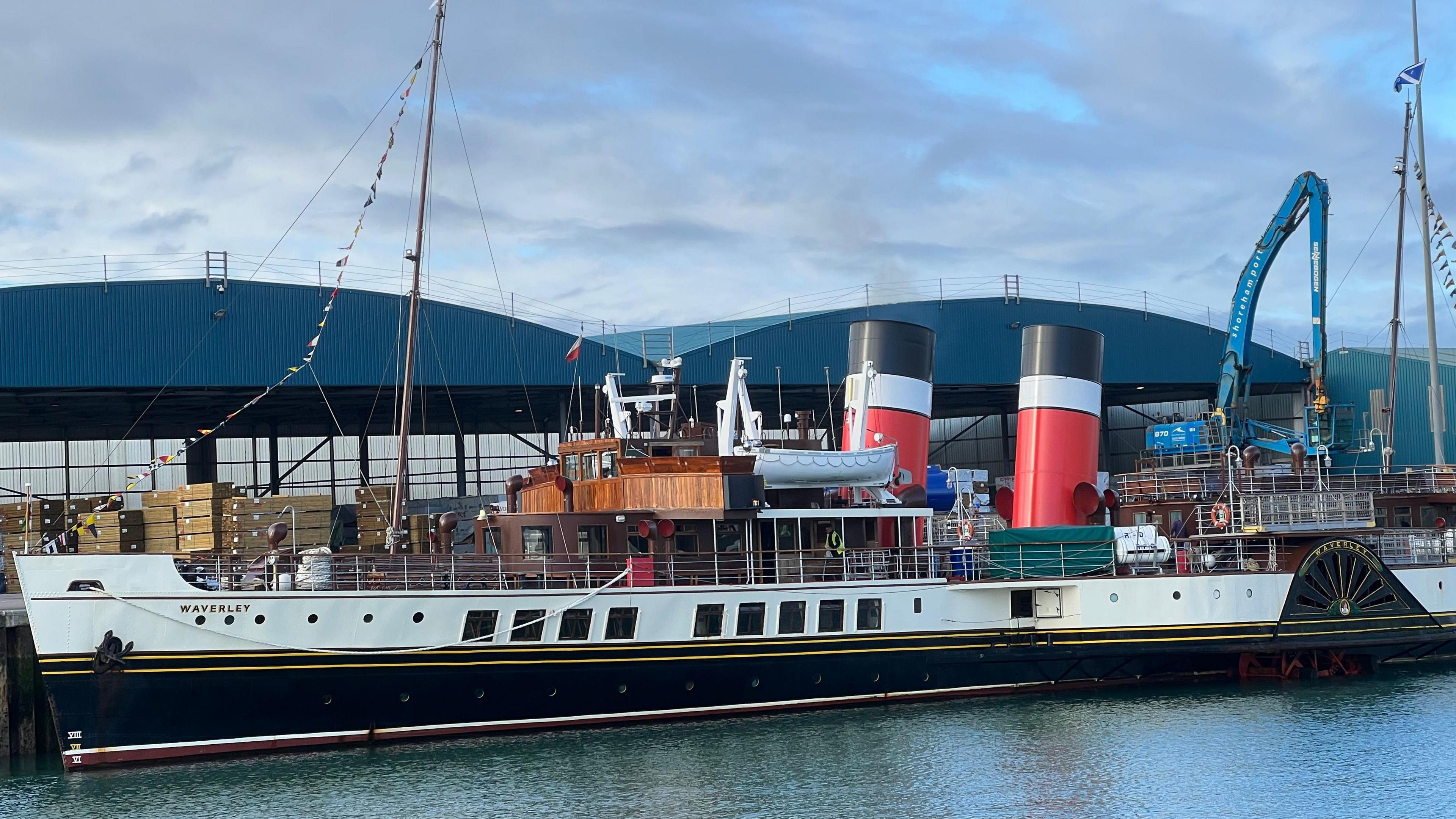 The Waverley from further afar, with Shoreham Port's warehouse and cranes behind her