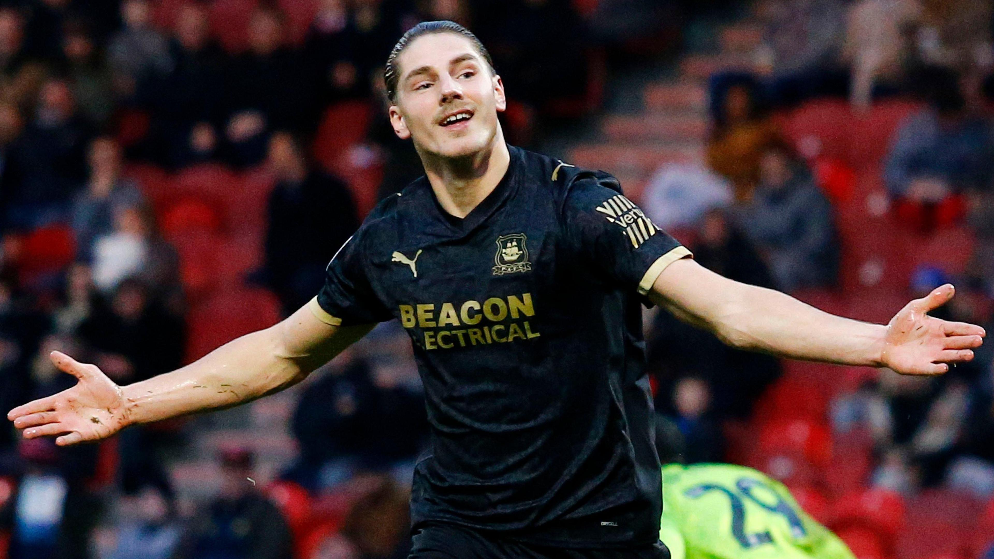 Lorent Tolaj, with arms outstretched, celebrates a goal for Plymouth at Doncaster