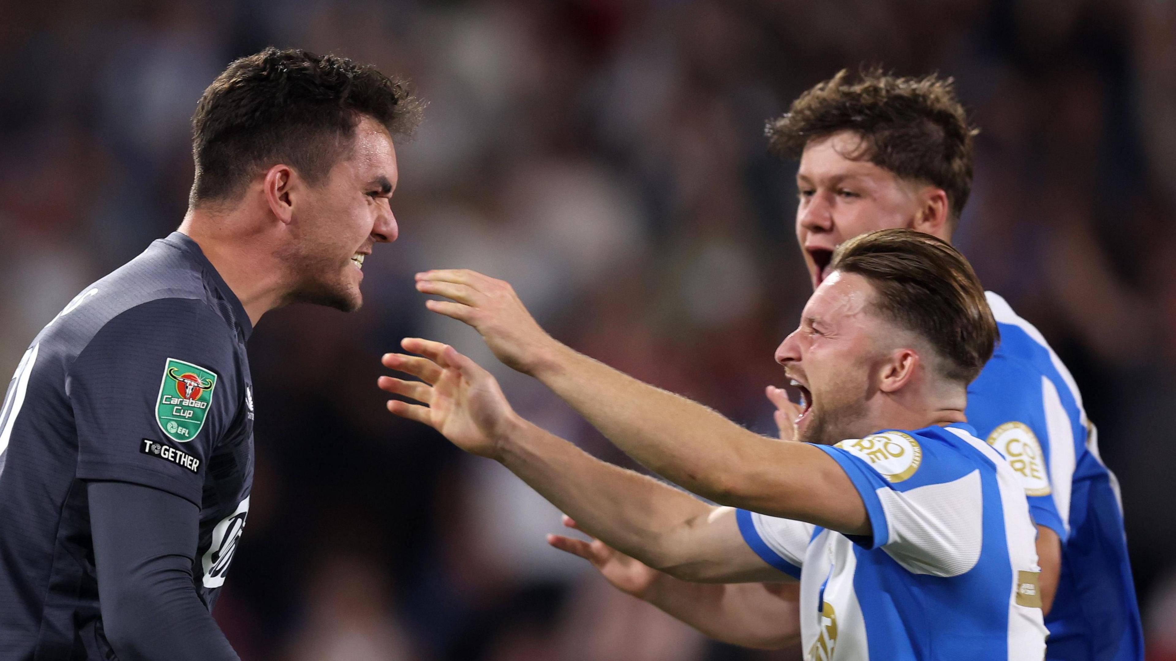 Alfie May celebrating with Huddersfield Town teammate Lee Nicholls after penalty shoot-out win over Leicester City