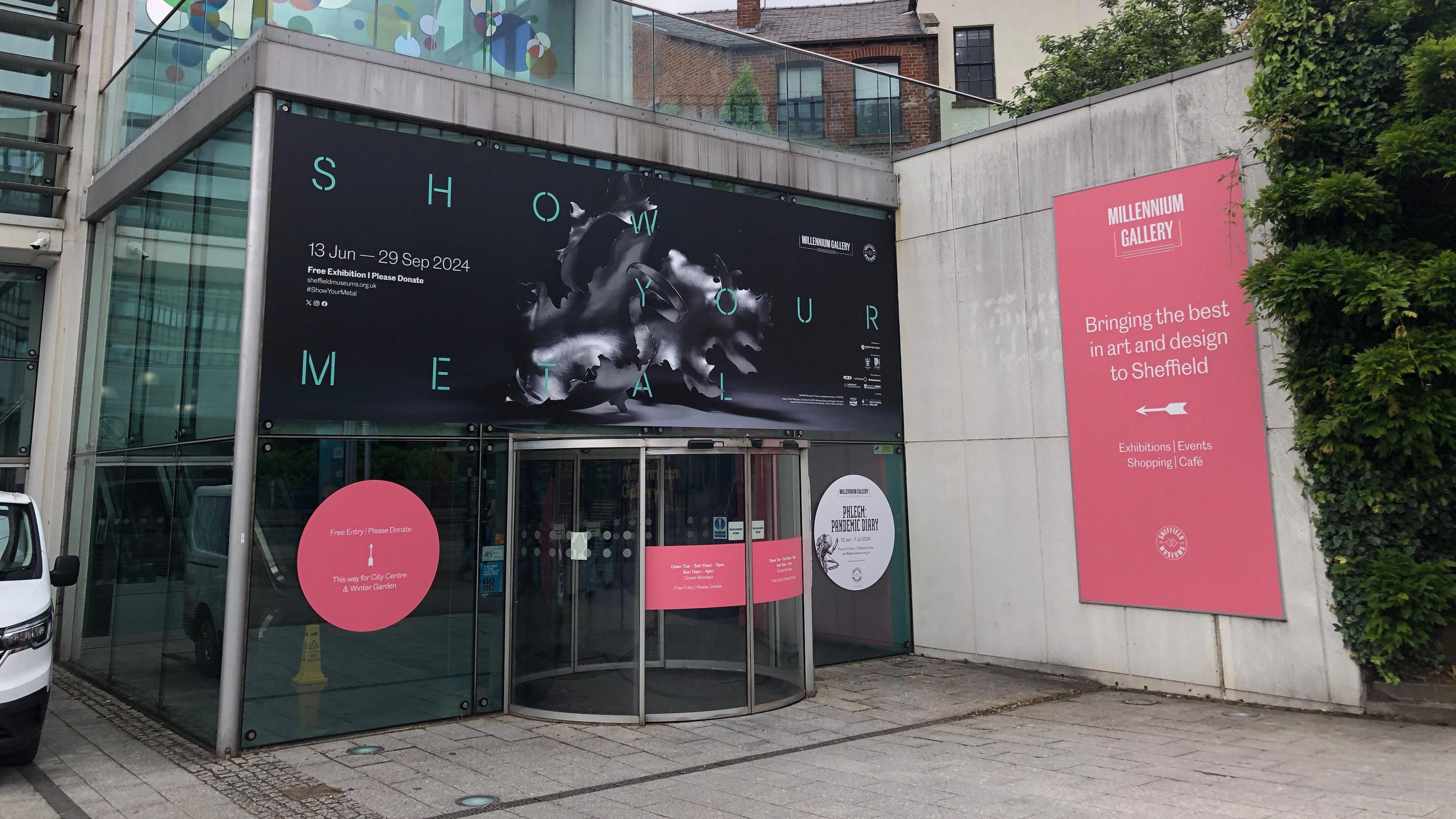 The entrance to Sheffield's Millennium Gallery. A revolving door at the front of a glass and concrete building.