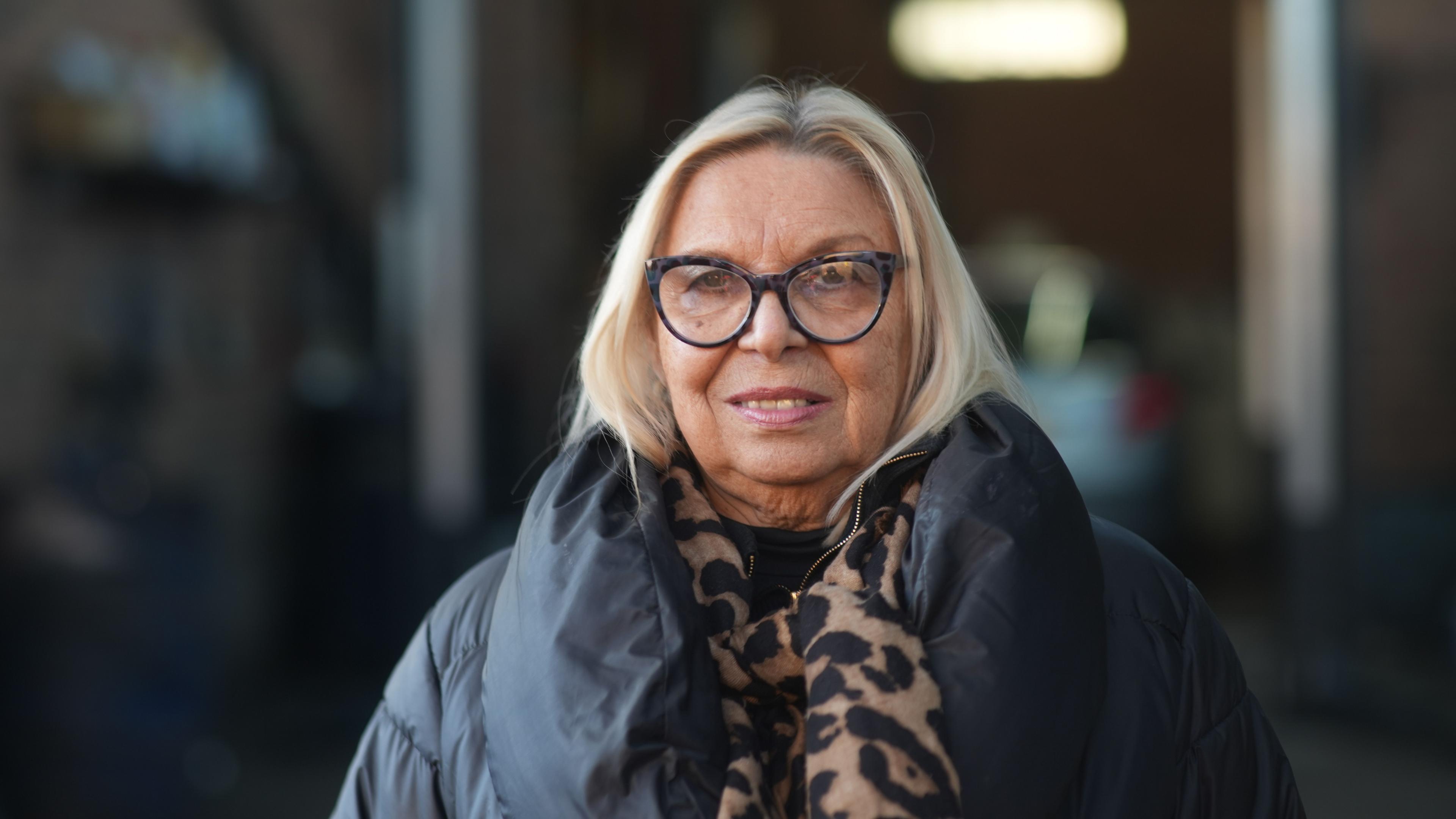 Mo Larkin wearing a leopard pattern scarf and a puffer jacket.