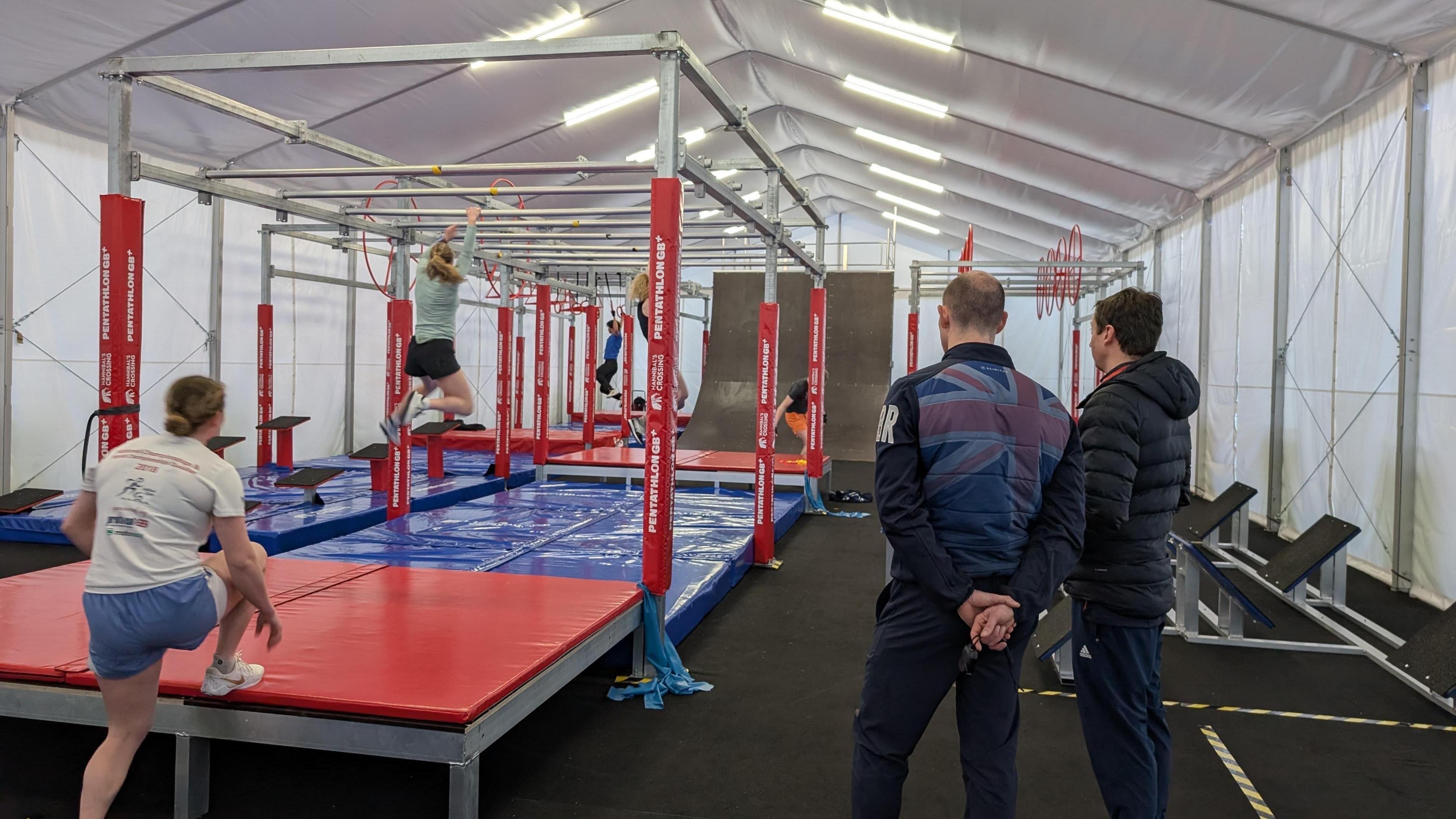 Athletes practise the new 'obstacle race' part of modern pentathlon at Team GB's base in Bath