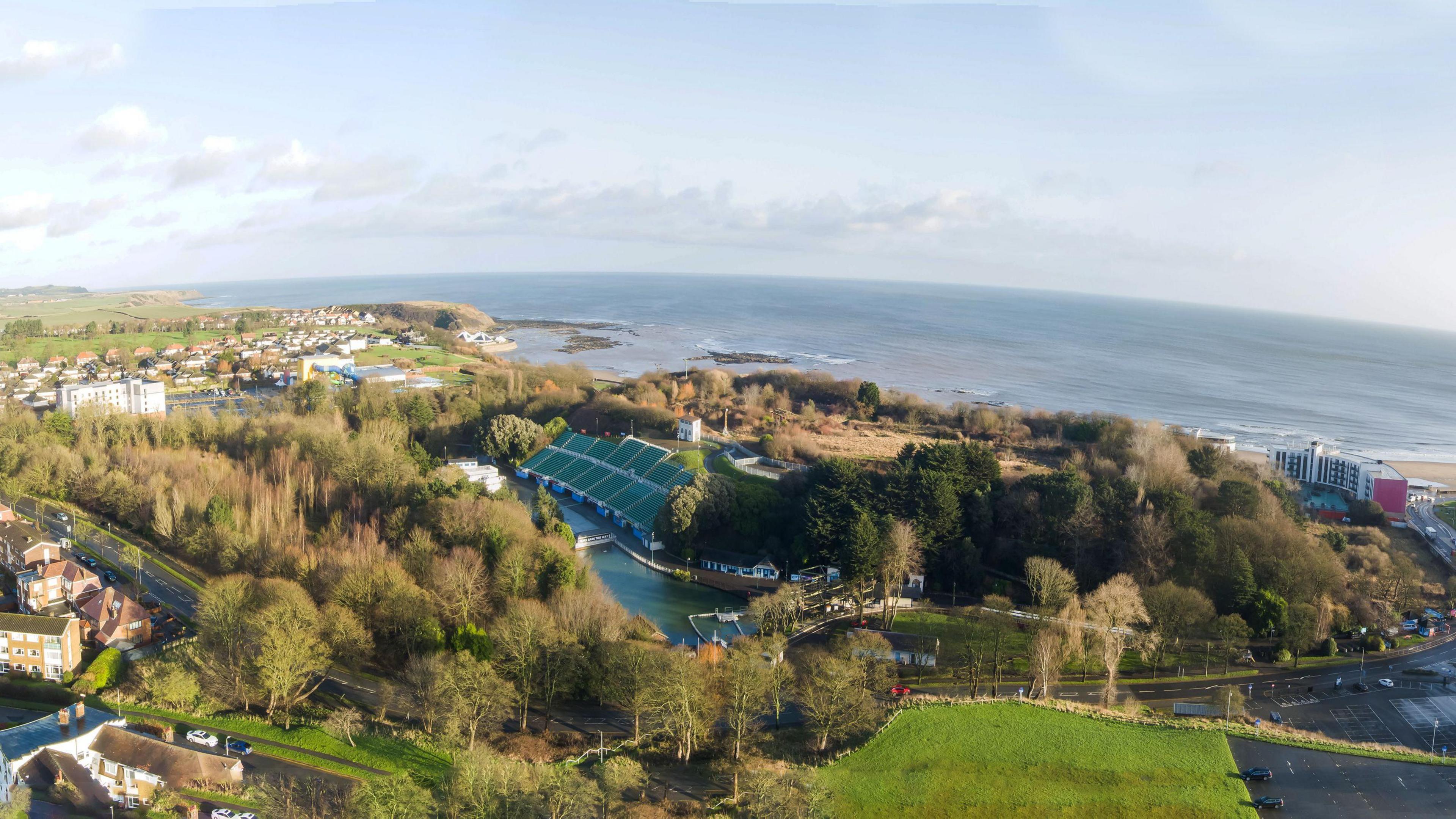 An aerial view of Scarborough's North Bay. Buildings, roads and trees can be seen, with the sea in the background.