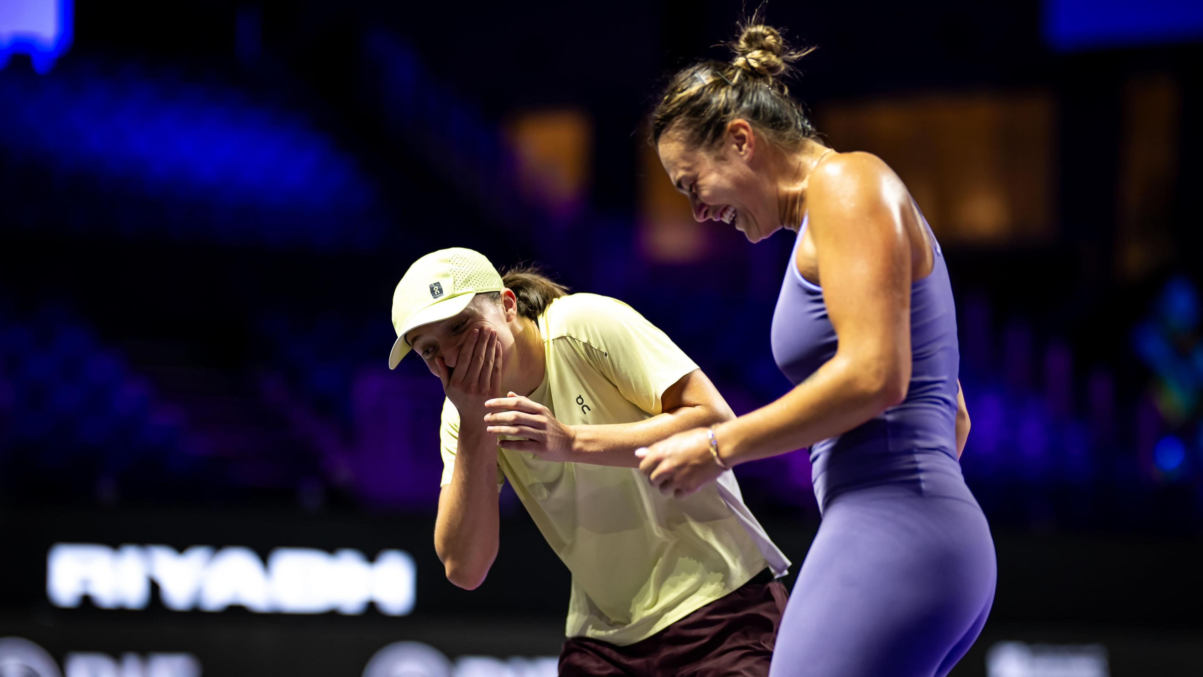 Swiatek and Sabalenka share a joke at the WTA Finals in Saudi Arabia last year