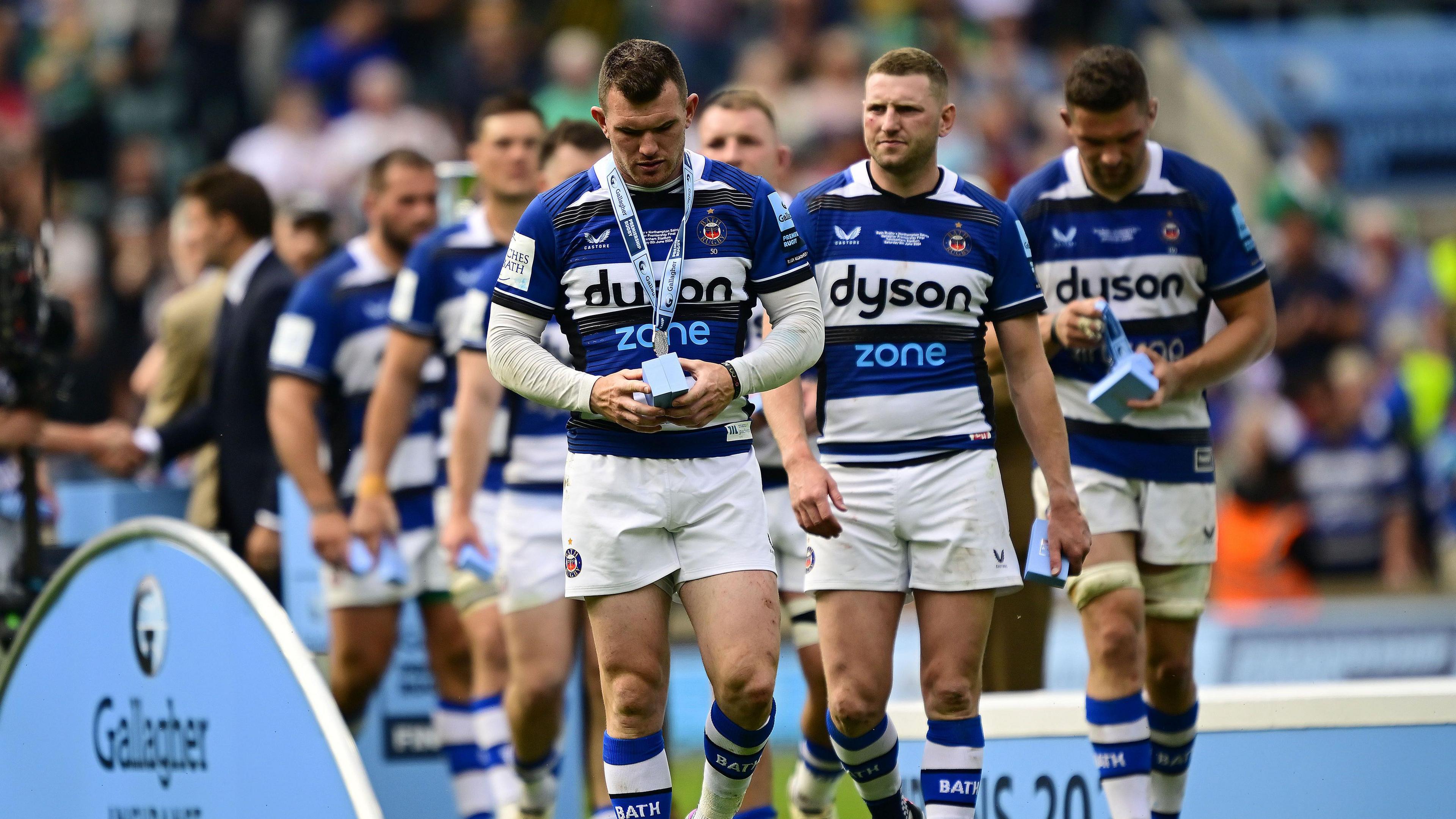 Bath players look dejected after collecting their runners-up medals at the Premiership final