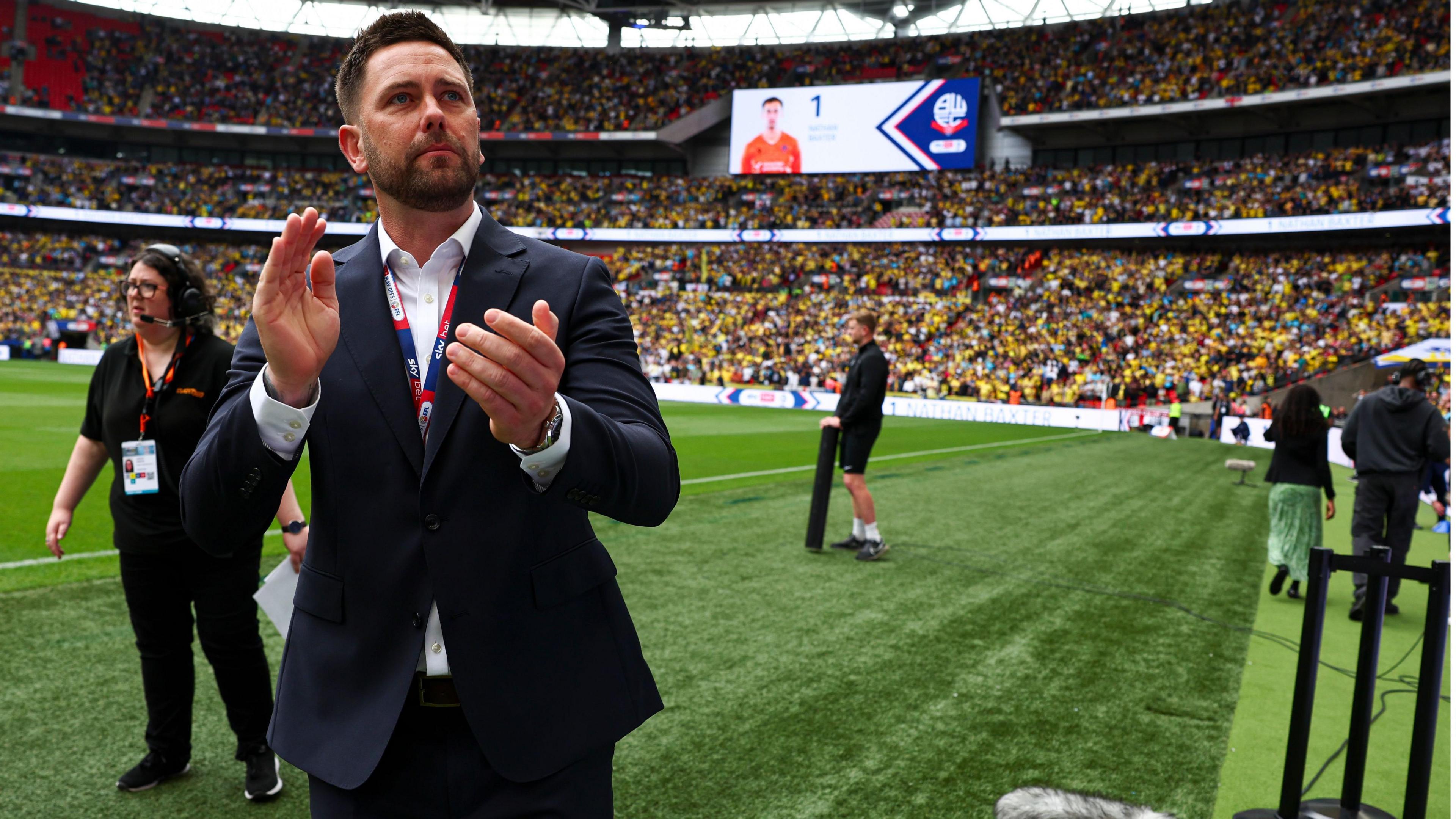 Des Buckingham applauding fans at Oxford United's League One play-off final against Bolton Wanderers last season