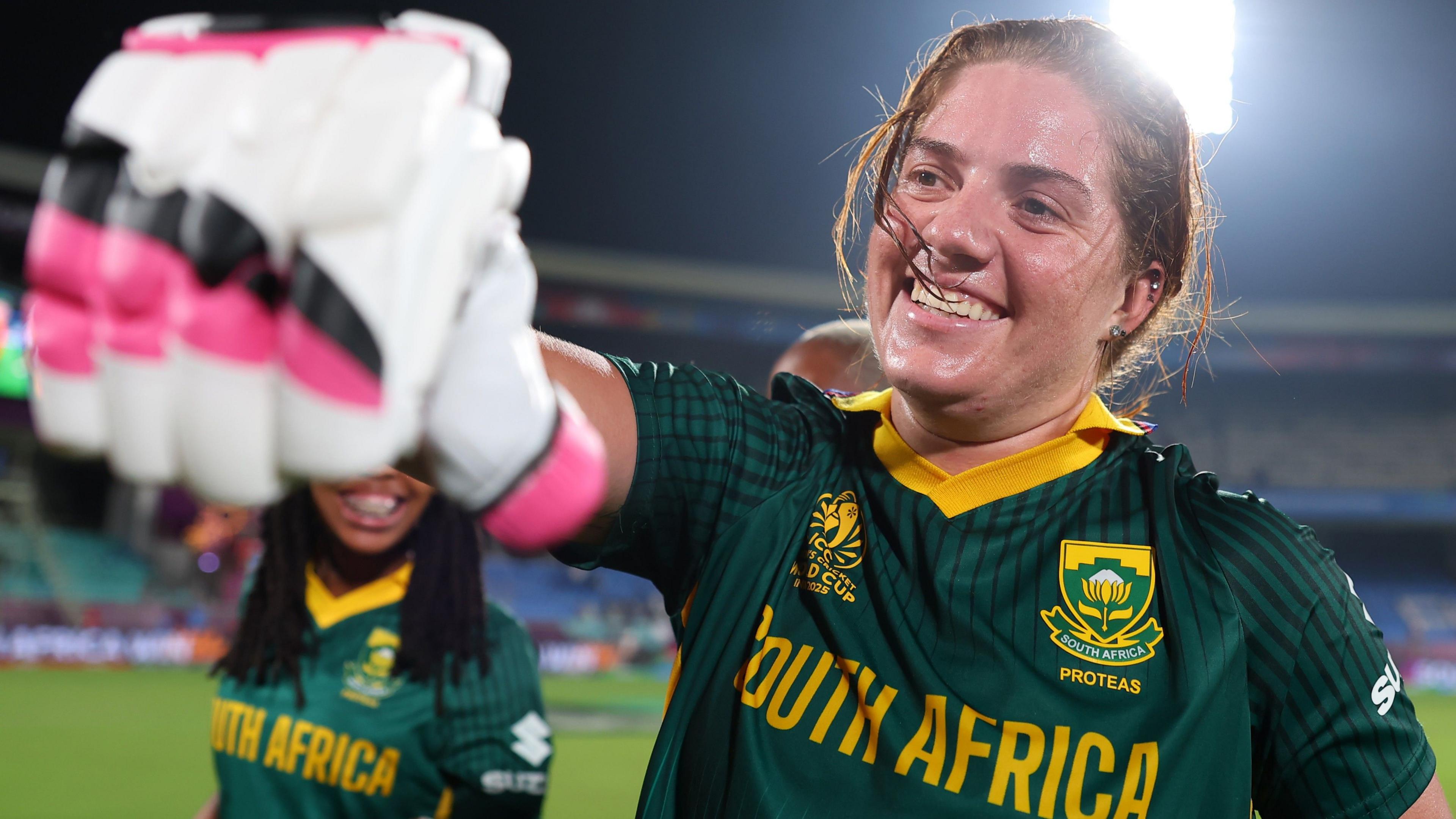 Nadine de Klerk fist-pumps a team-mate with a smile on her face