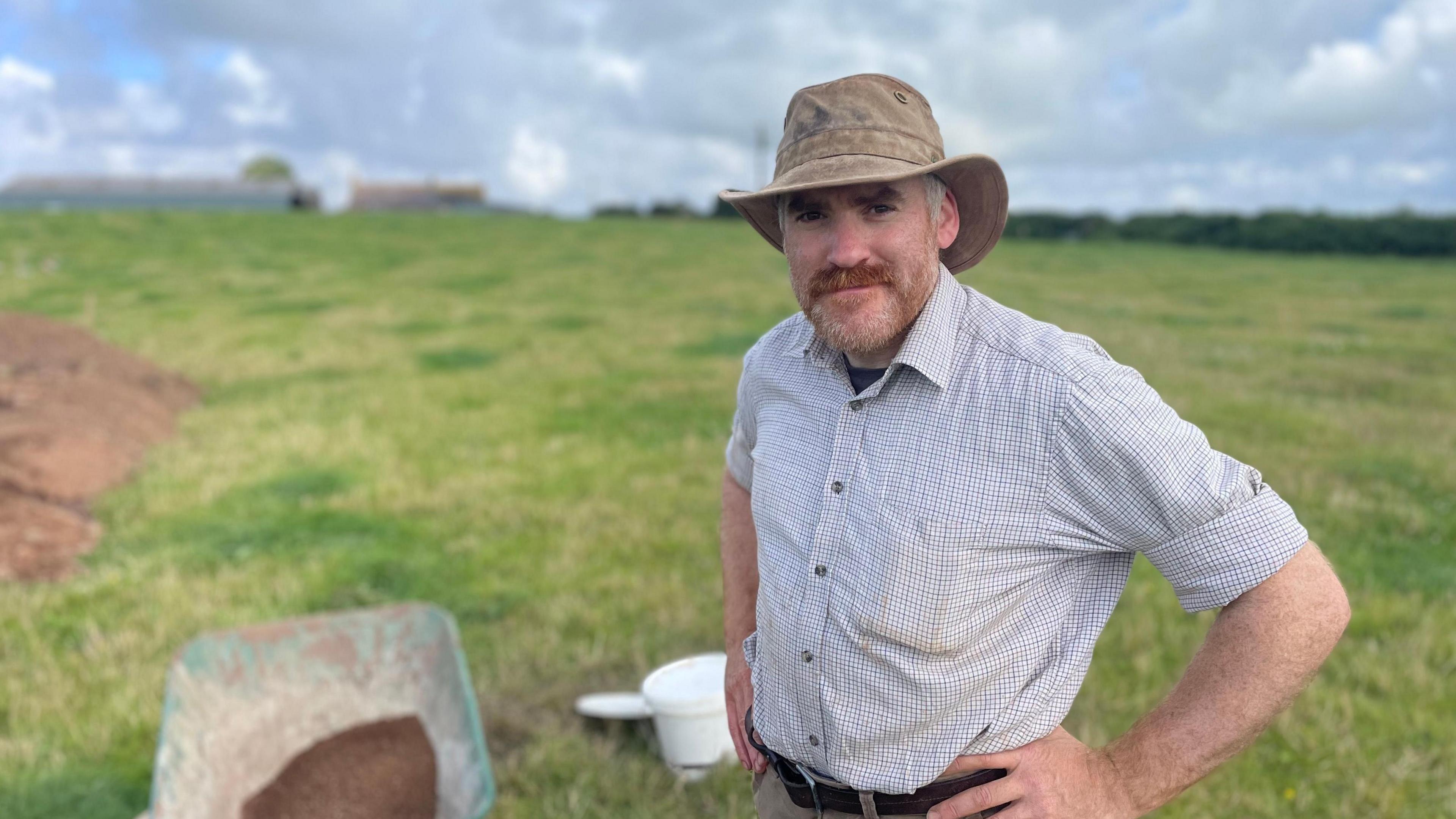 Don O’Meara, who wears a sun hat and checked shirt, at the dig site at High Tarns Farm.