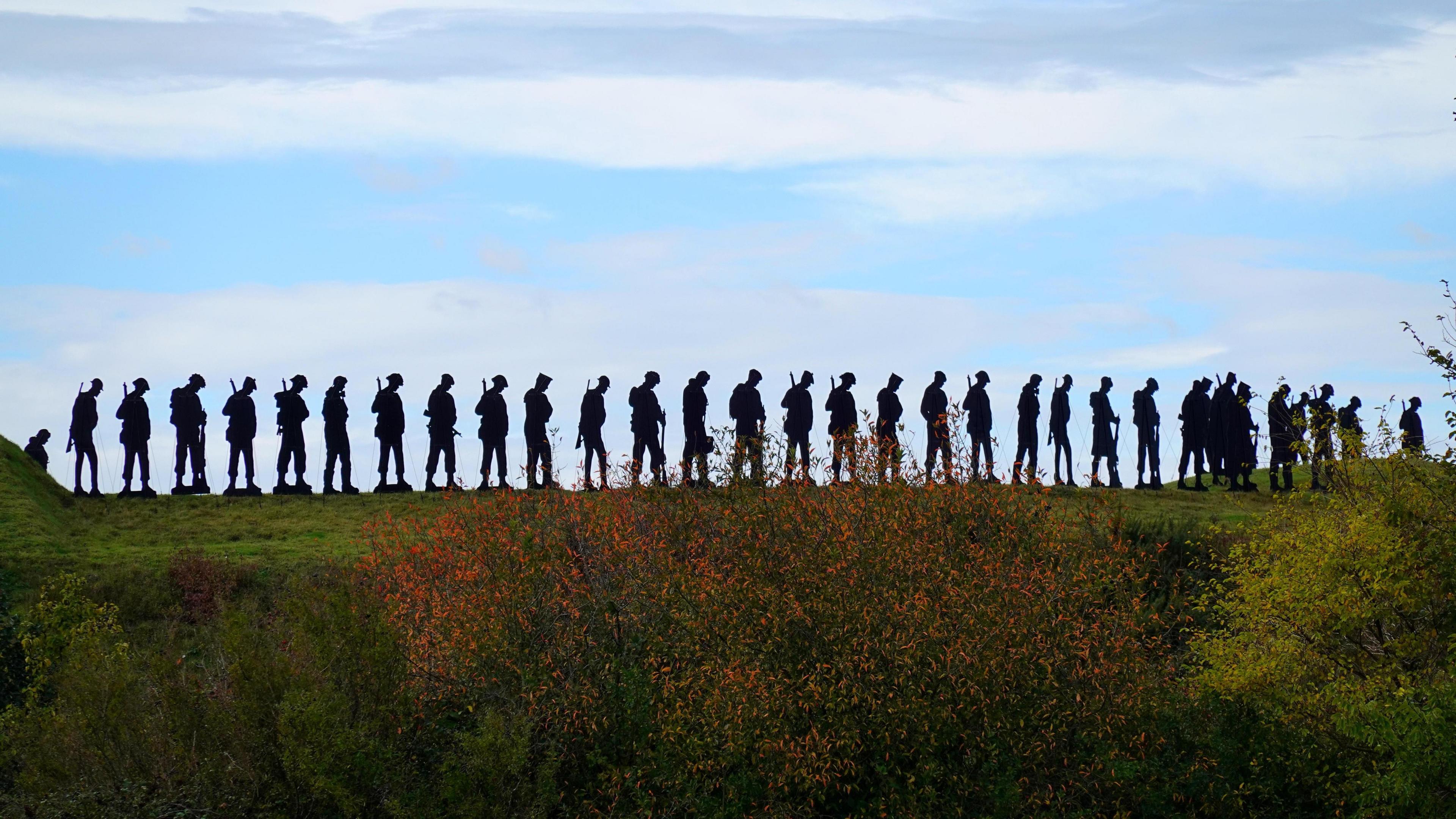 A row of silhouettes of army troops.