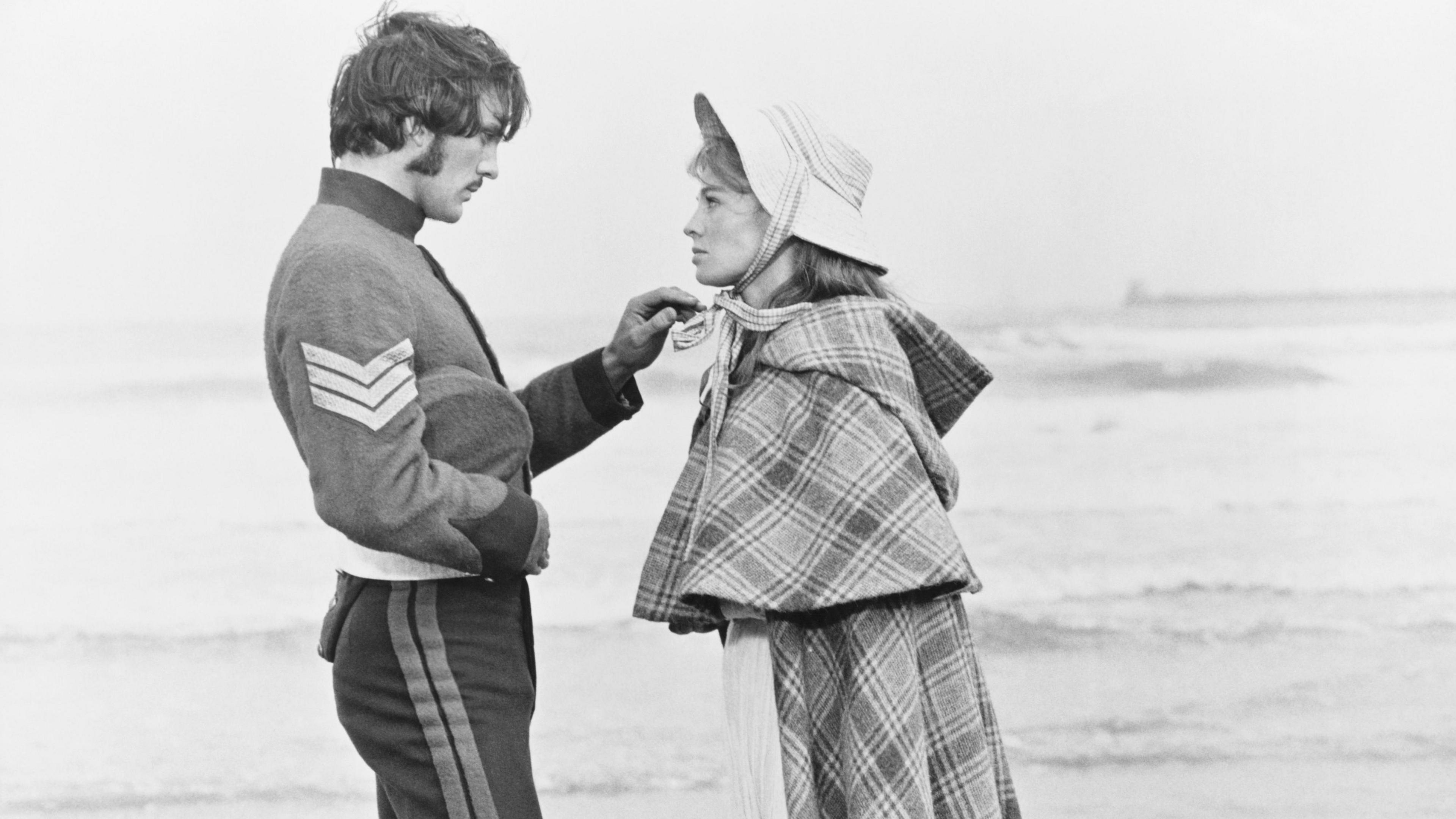 Terence Stamp and Julie Christie - as Sergeant Troy and Bathsheba Everdene - in Far From the Madding Crowd. Stamp is in military uniform. He is playing with the bonnet of Julie Christie's hat.