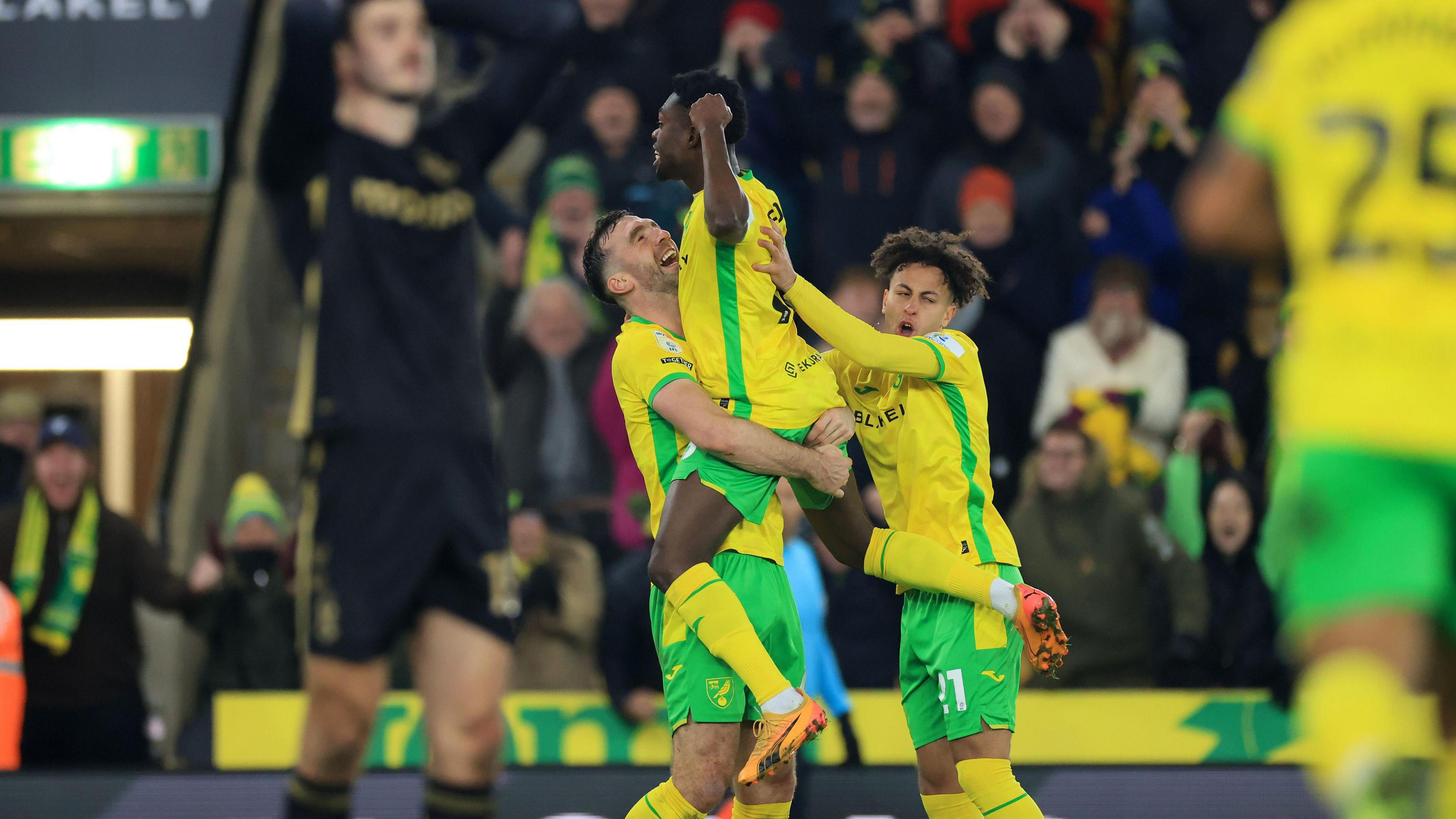 Amankwah Forson is lifted off the ground by Norwich team-mates after scoring against Coventry