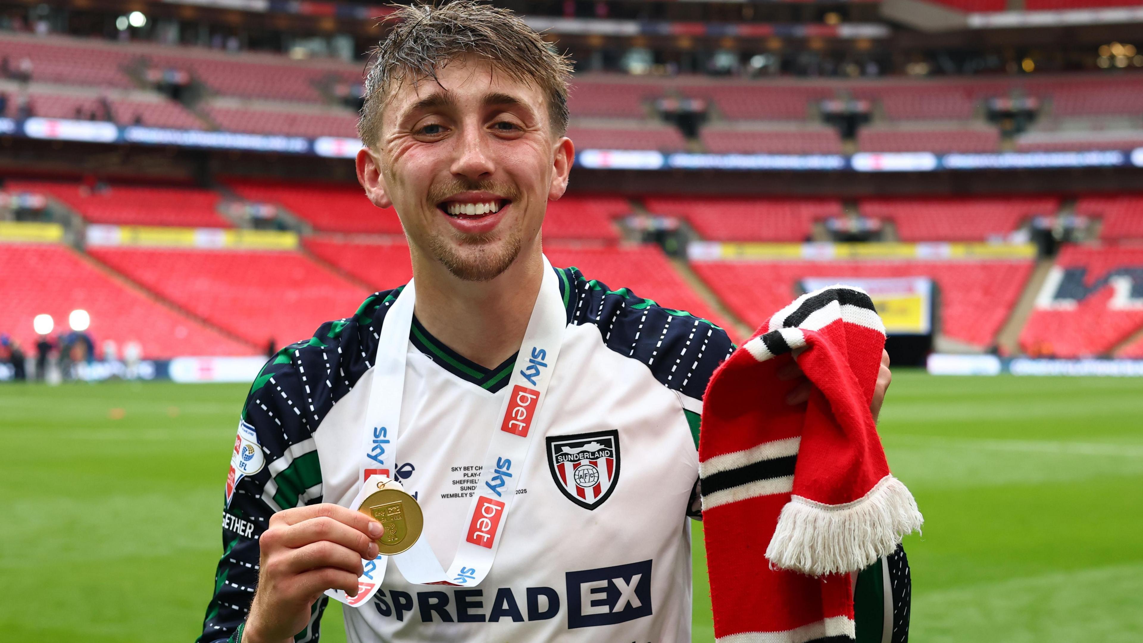 Dan Neil holds his medal at Wembley following Sunderland's victory over Sheffield United