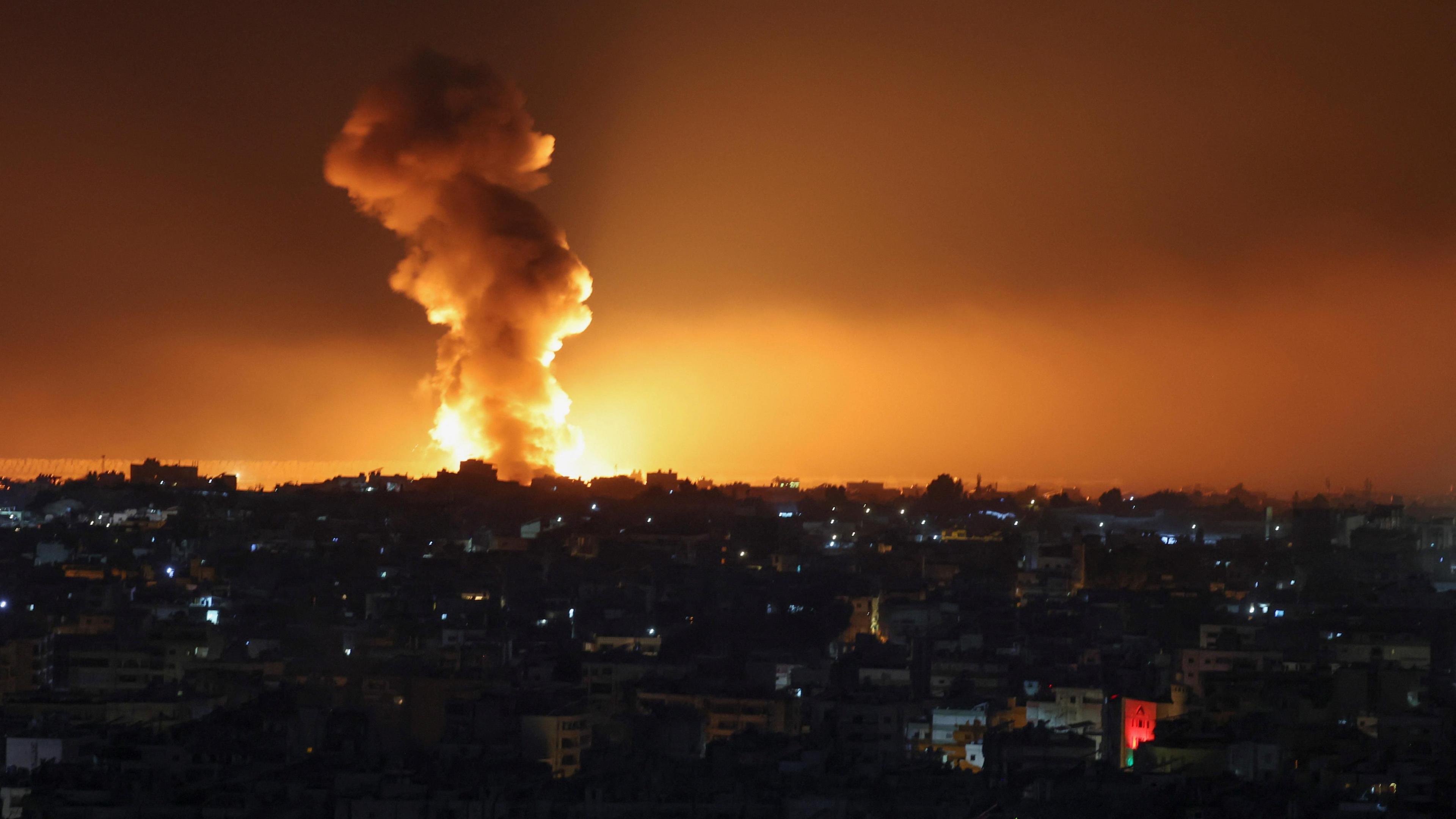 A night time image of southern Beirut, smoke is rising from a bright blaze on the skyline