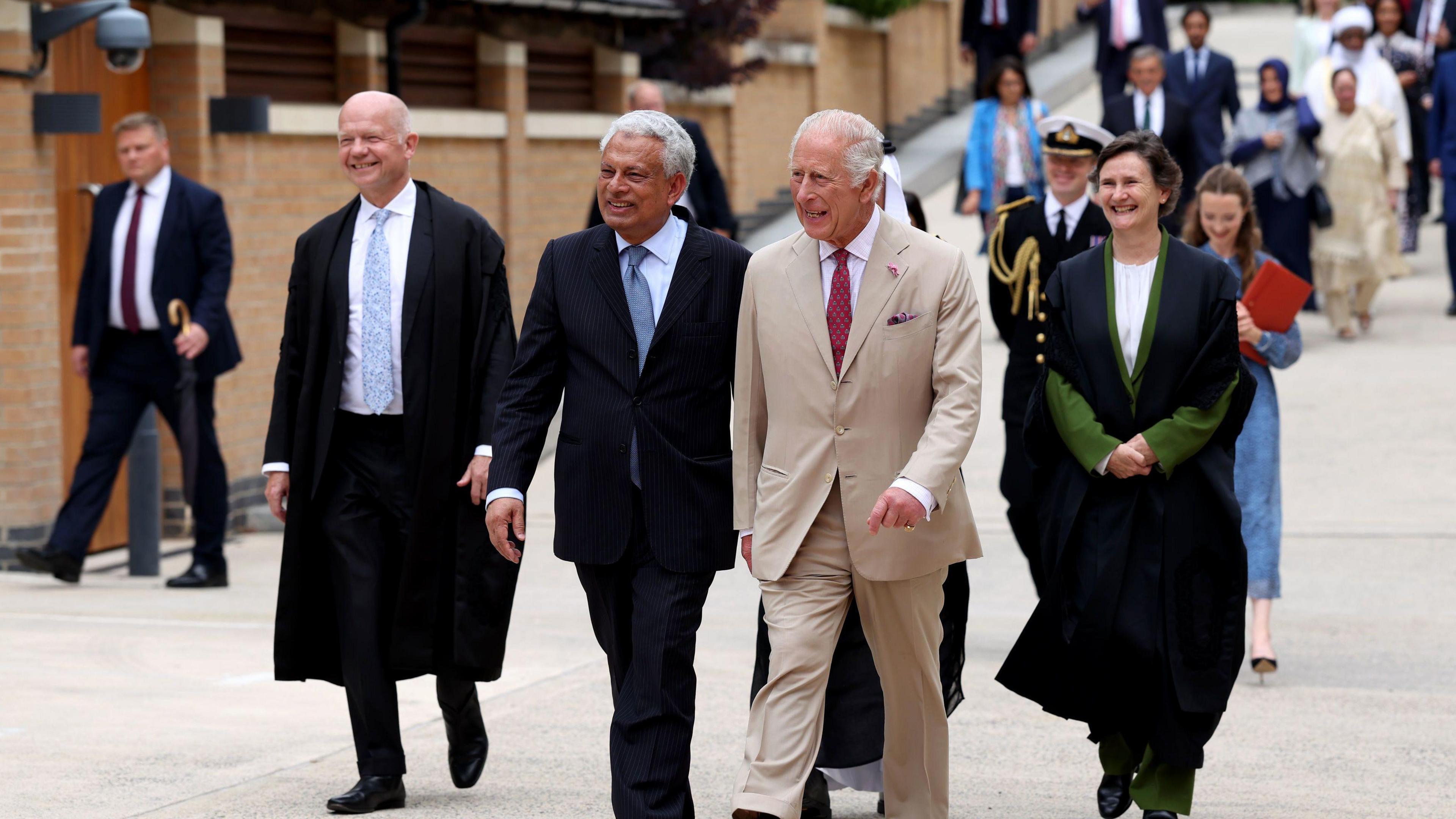 King Charles III (centre) is guided around the Oxford Centre for Islamic Studies by the director Farhan Nizami (centre left) alongside Chancellor of the University of Oxford William Hague (left).