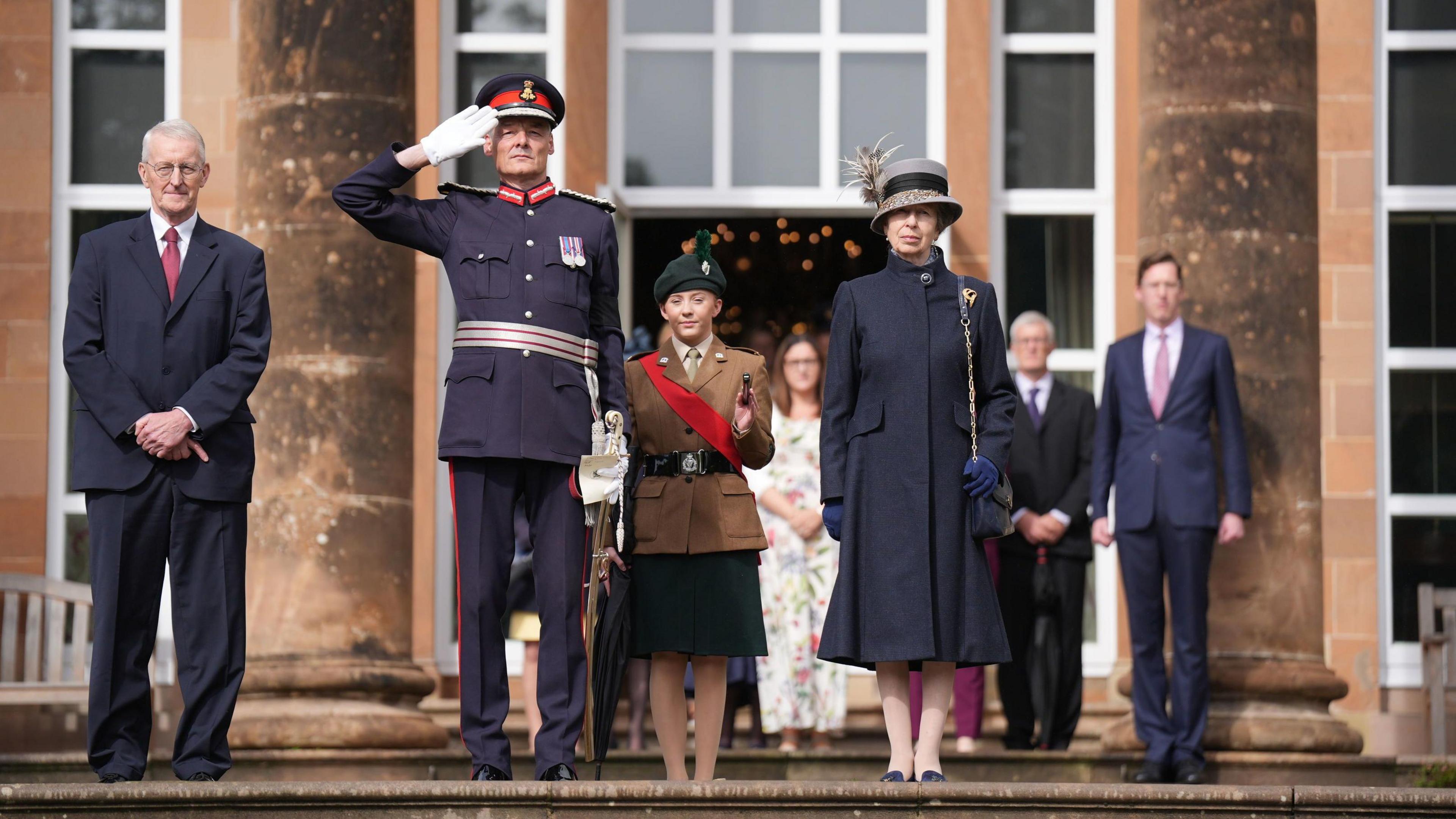 The Princess Royal stands beside NI Secretary Hilary Benn and others outside Hillsbrough Castle.