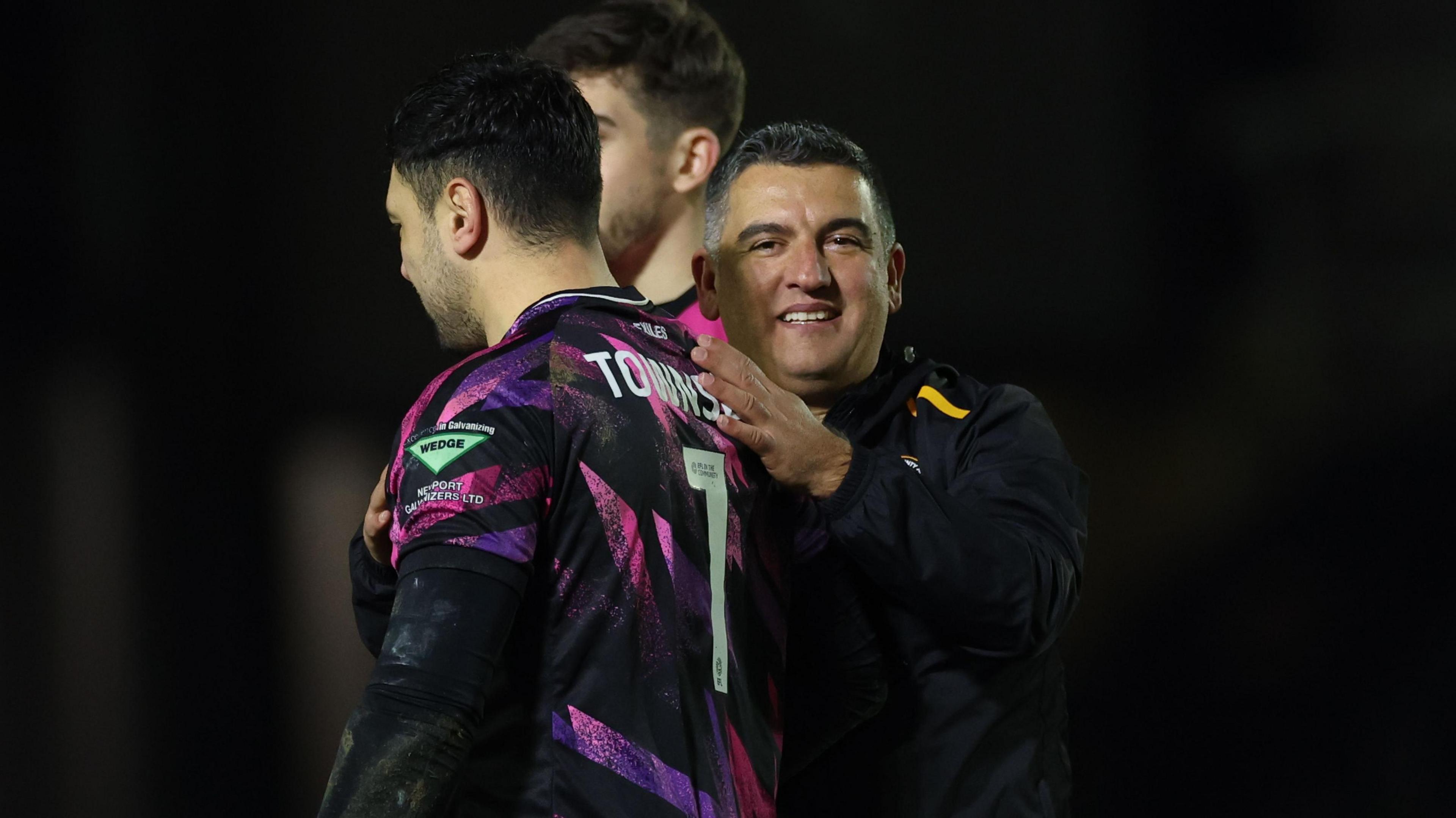 Nelson Jardim pats the back of Newport goalkeeper Nick Townsend 